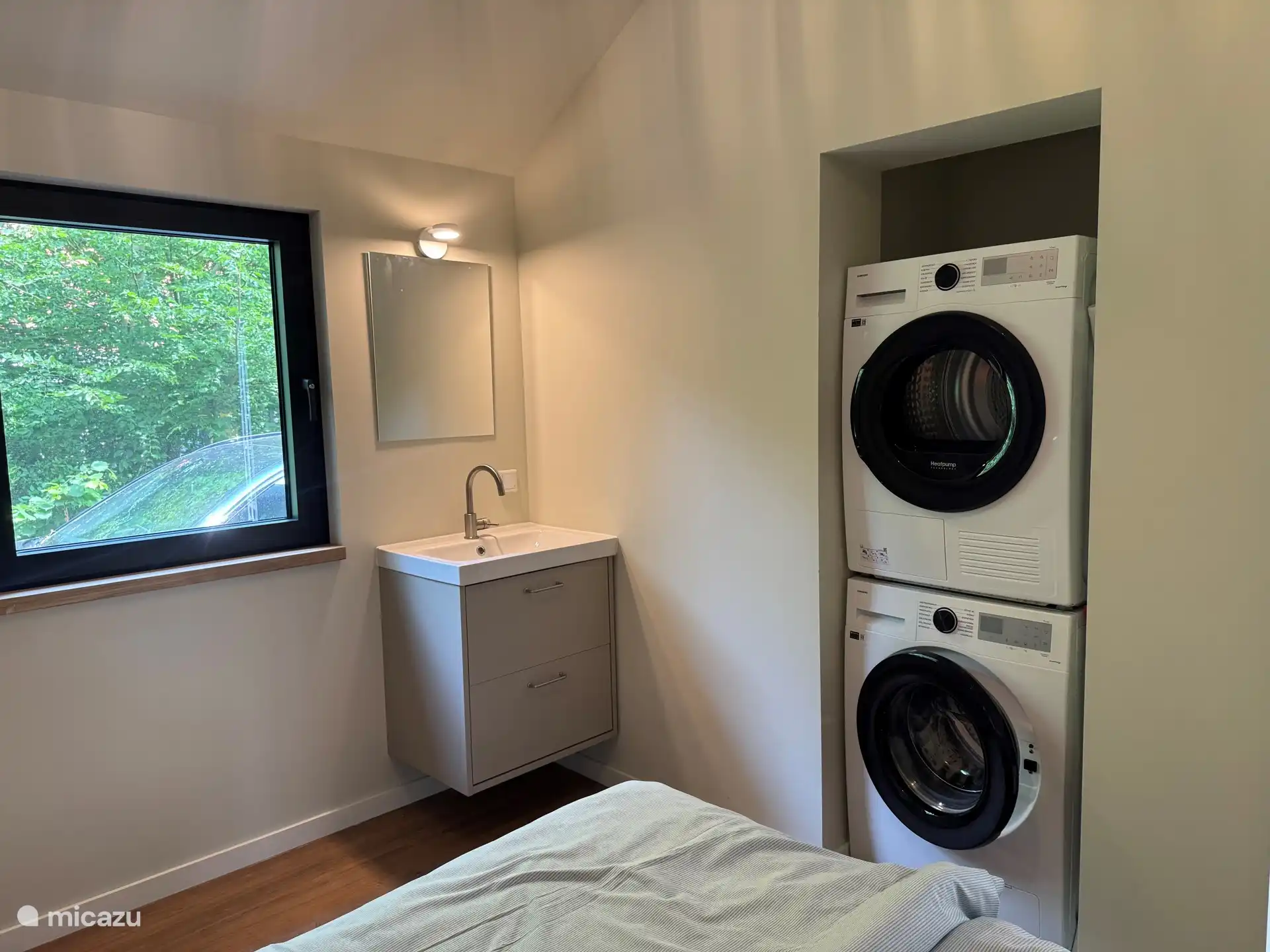 Slaapkamer achter met eigen wastafel wasmachine en droger