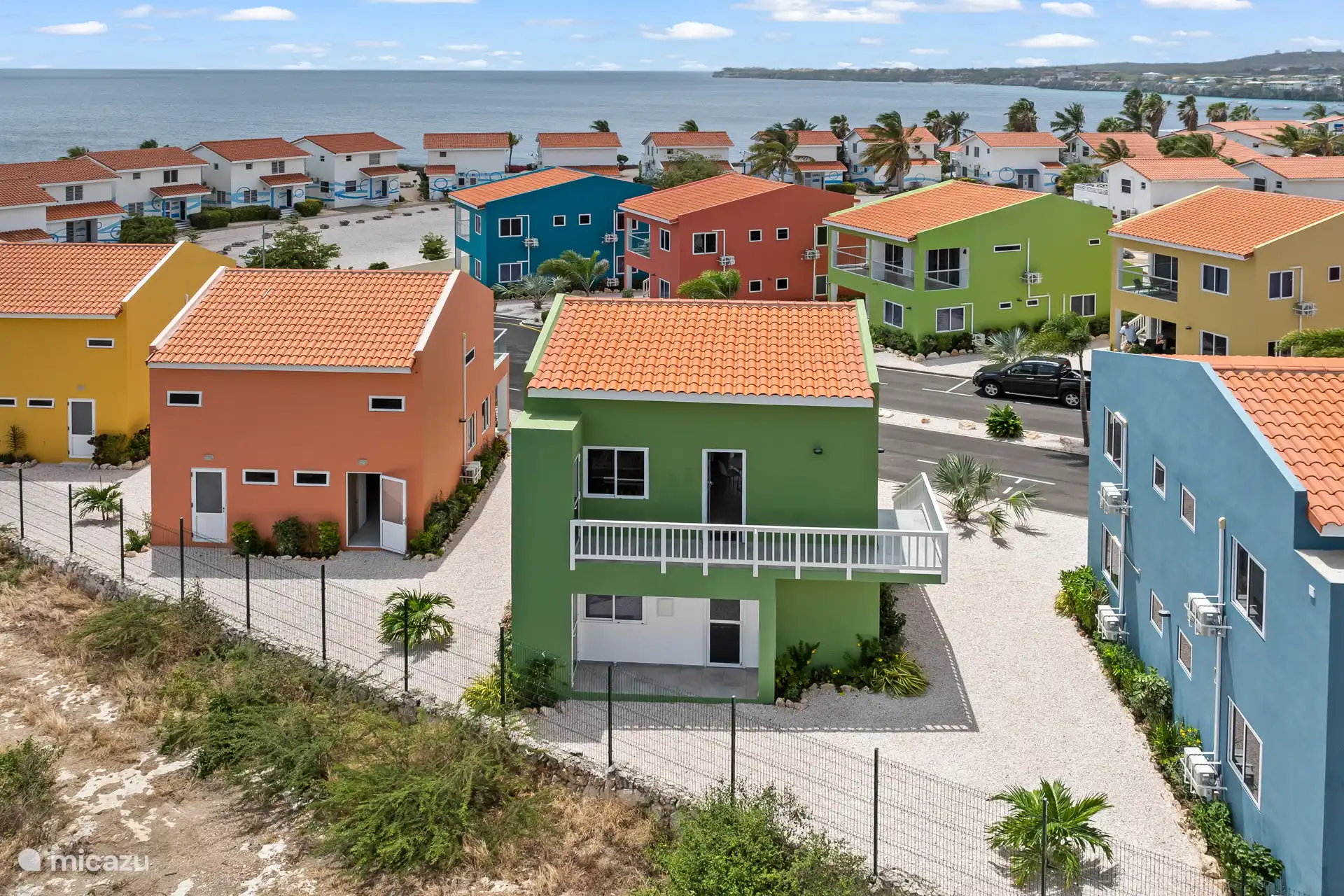 Bird's eye view of an attractive park with charmingly coloured holiday homes.
