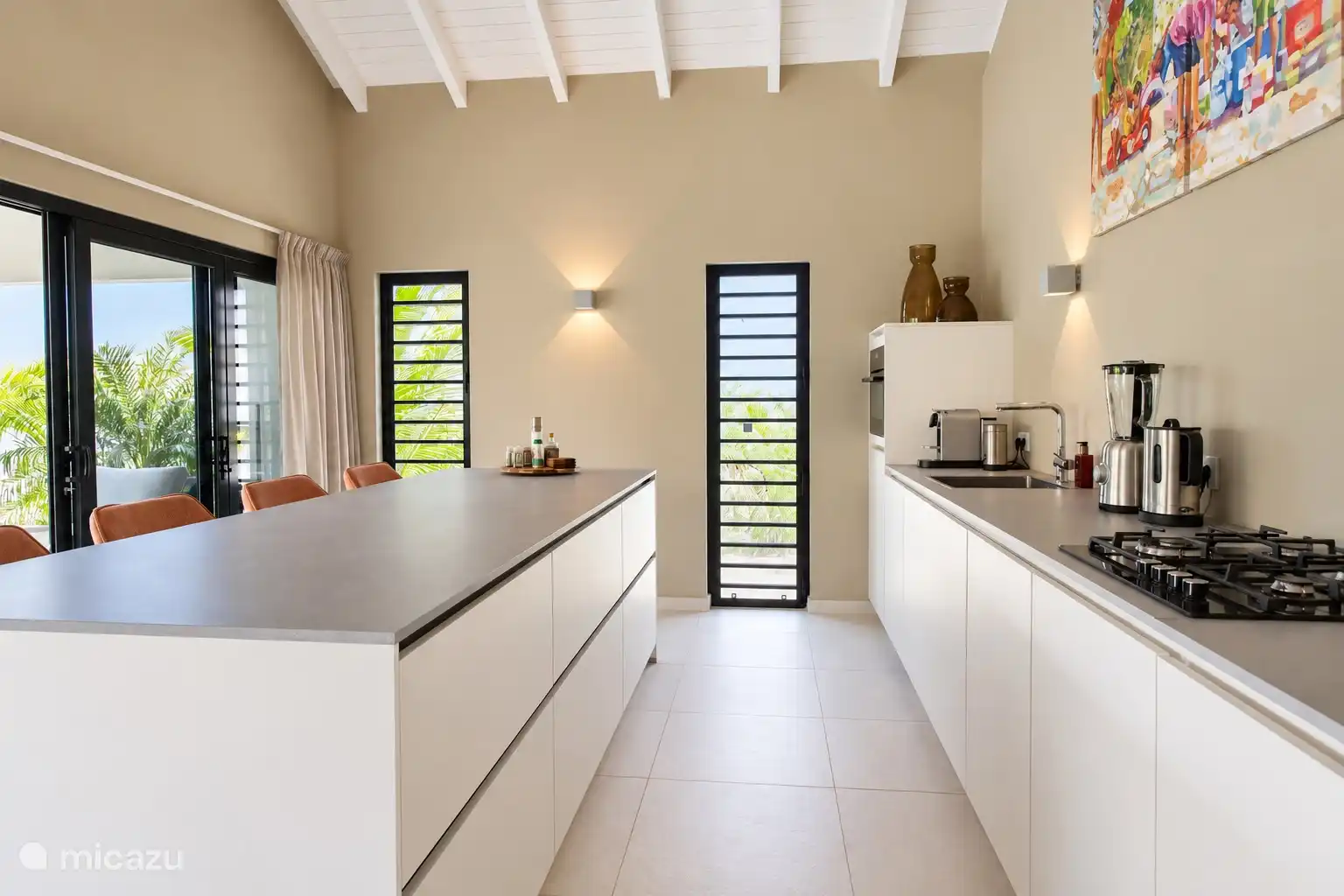 The spacious kitchen with ample storage space, modern appliances and very fully furnished
