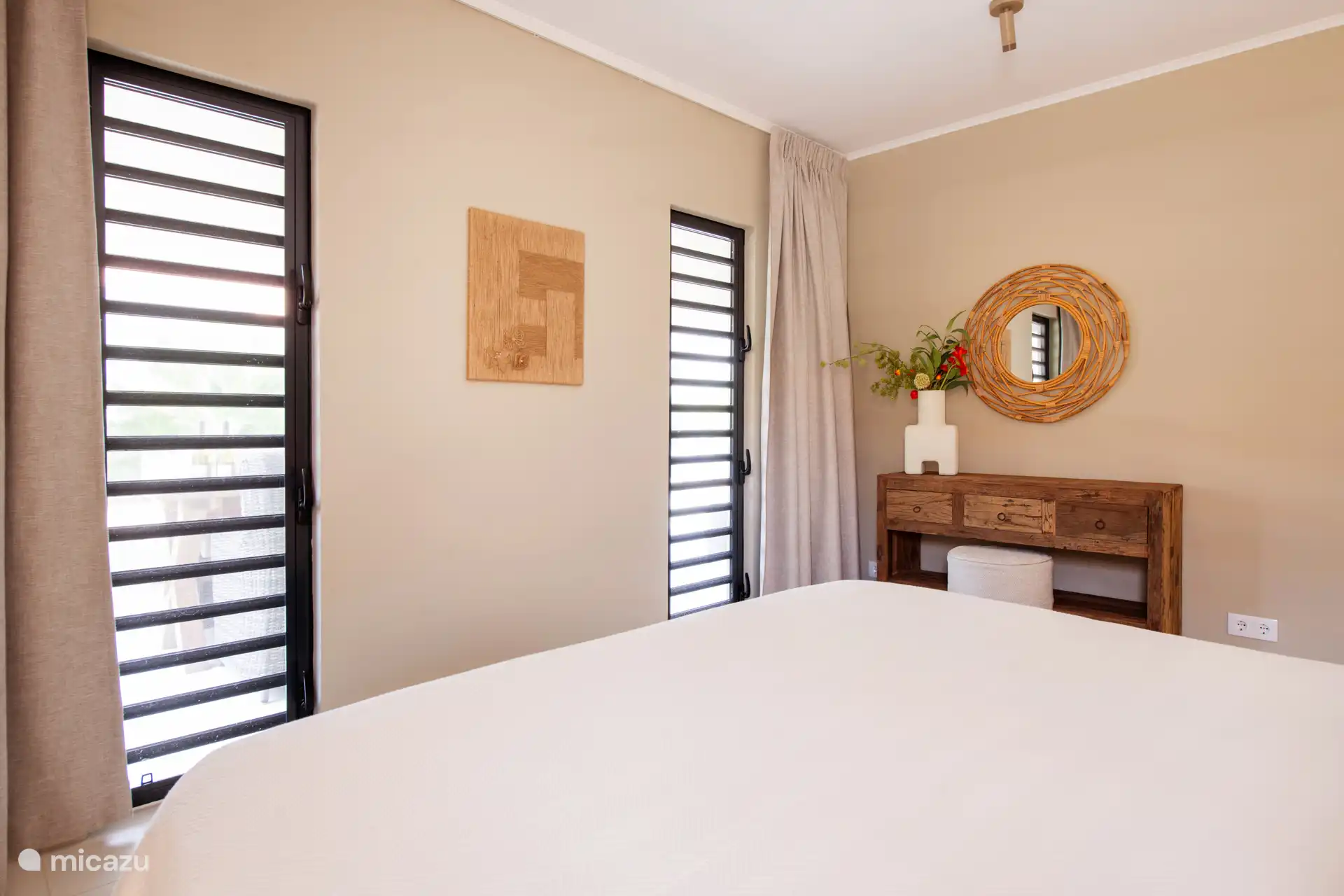 Shutter windows in the second bedroom provide a lovely breeze. Close the curtains in the evening for extra privacy