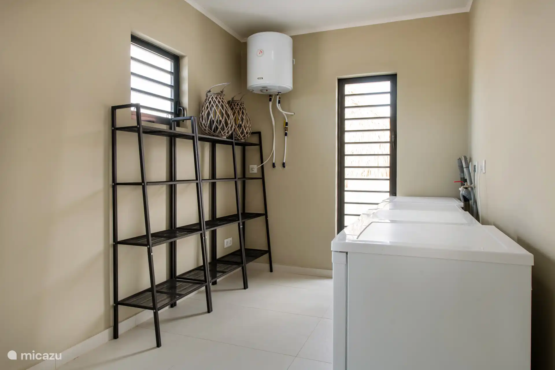 The utility room. Nice extra space for your groceries, a dryer and washing machine and an extra fridge and freezer (on or off as desired)