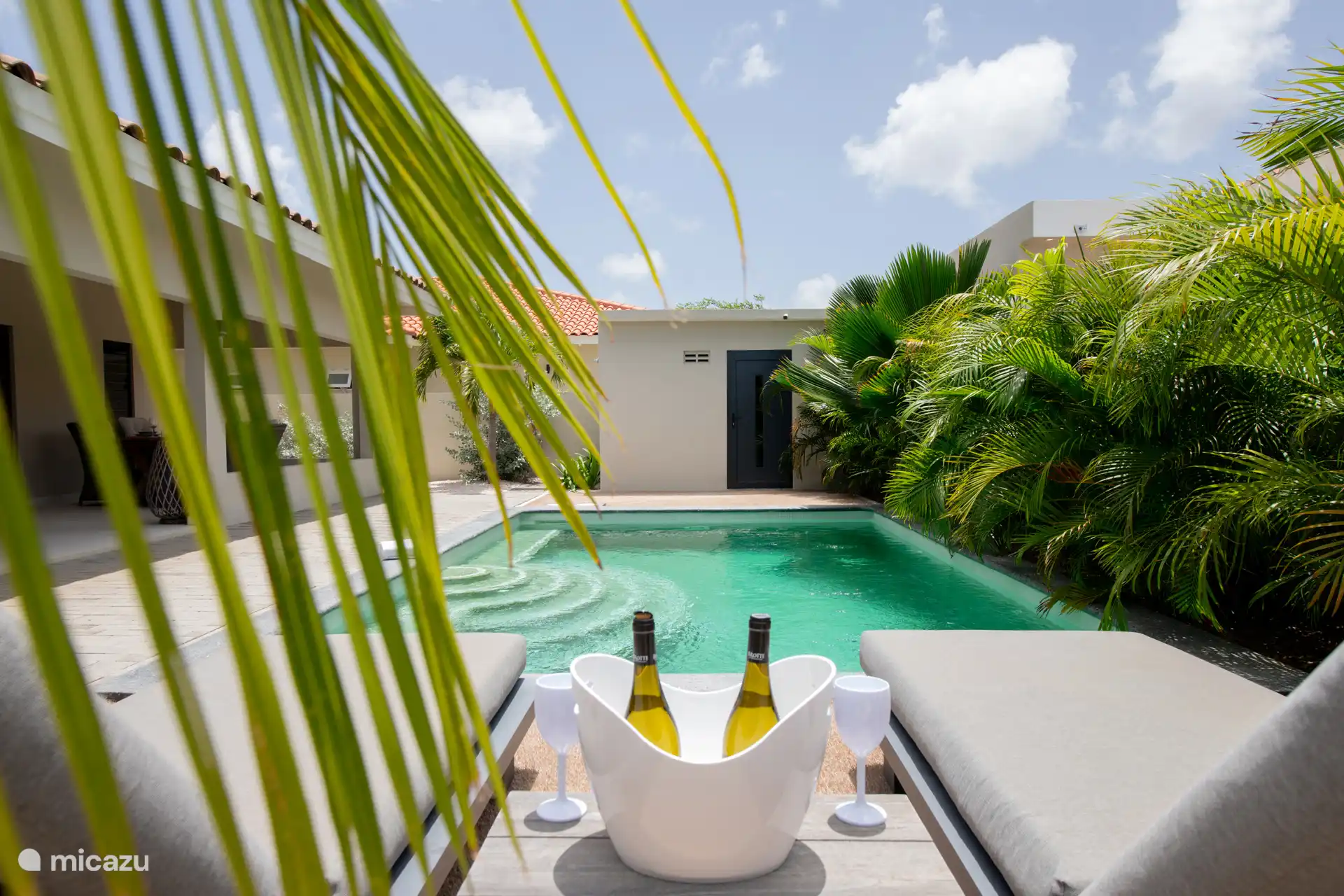 Lovely sunbeds with thick cushions by the pool