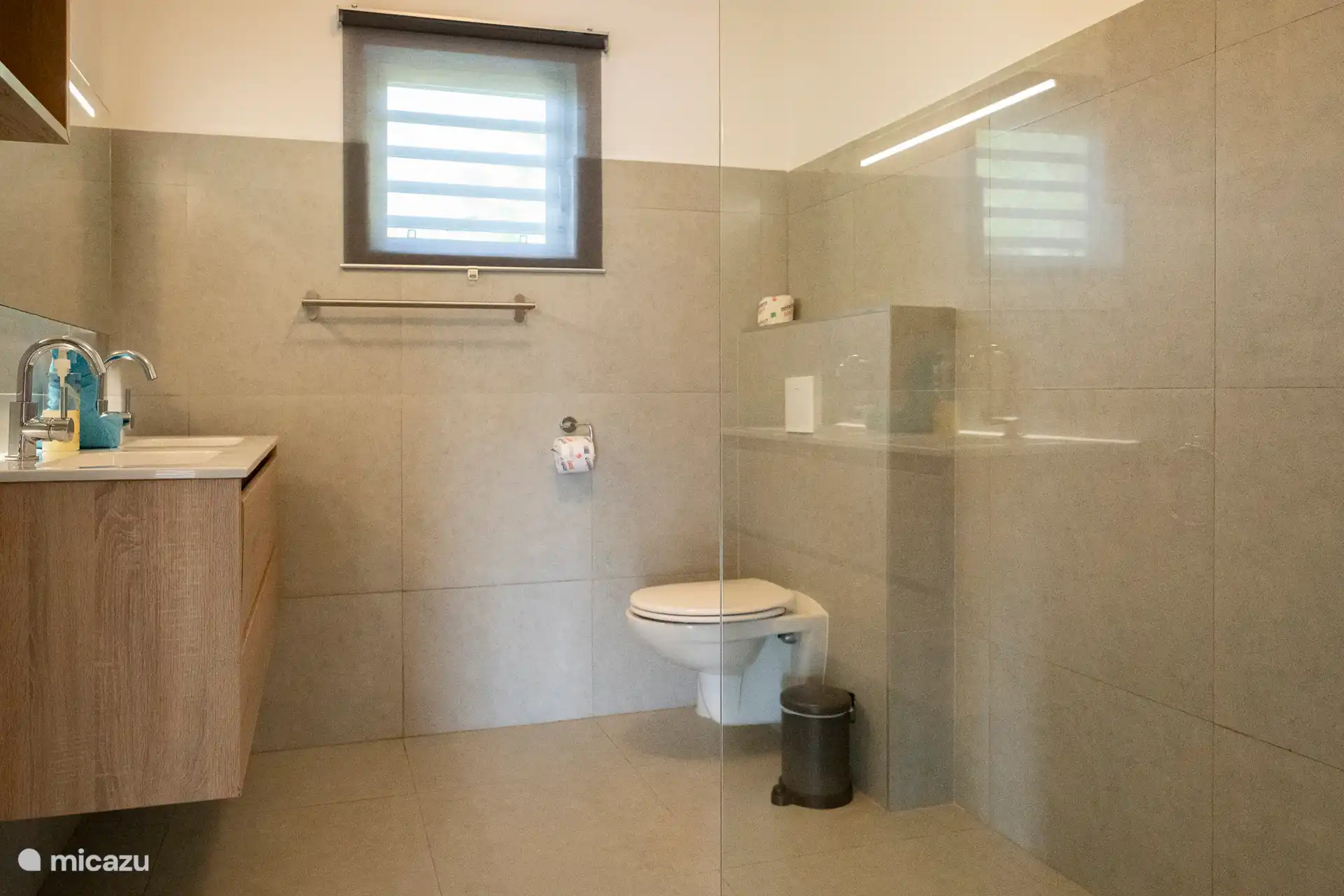 Ein geräumiges, modernes Badezimmer mit begehbarer Dusche, Doppelwaschbecken und viel Licht. Schlank und ausgestattet mit allem, was Sie für einen komfortablen und entspannten Aufenthalt brauchen.