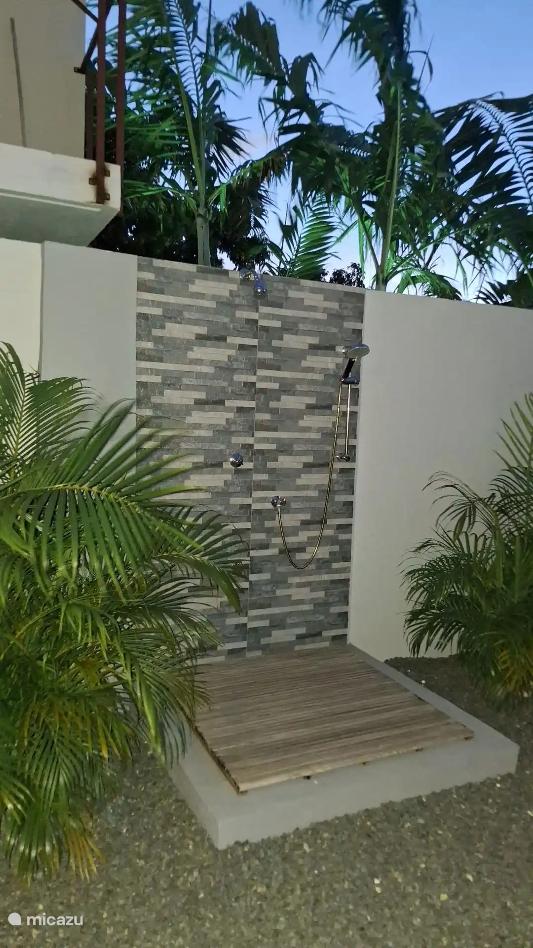 Lovely outdoor shower next to the pool.