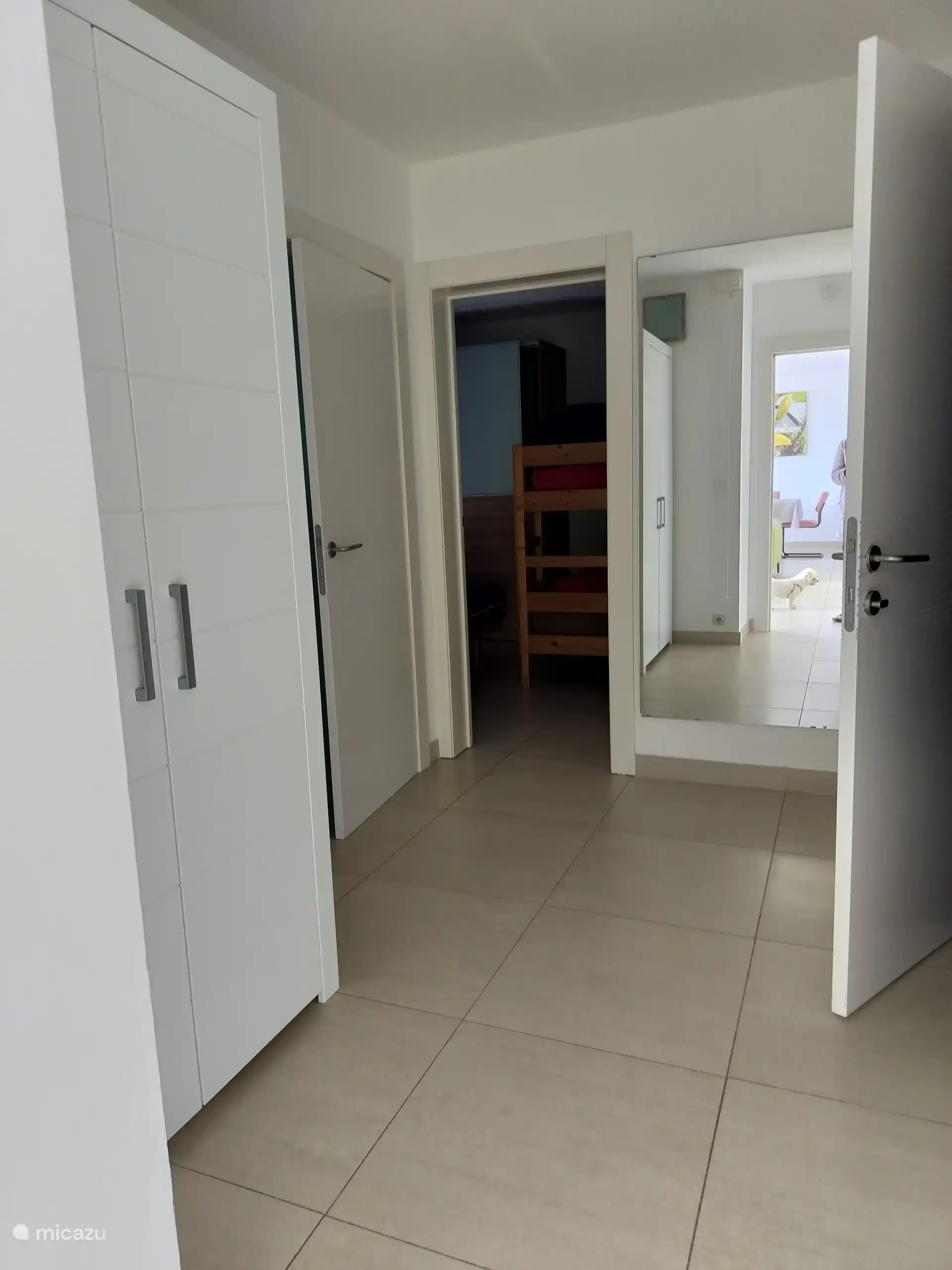 nachthal met toegang tot de 2 slaapkamers en de badkamer.  kast met spelletjes 