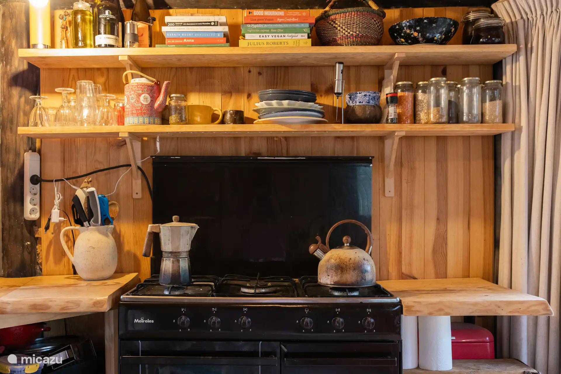 The kitchen with gas oven, coffee maker and a kettle and milk frother. 