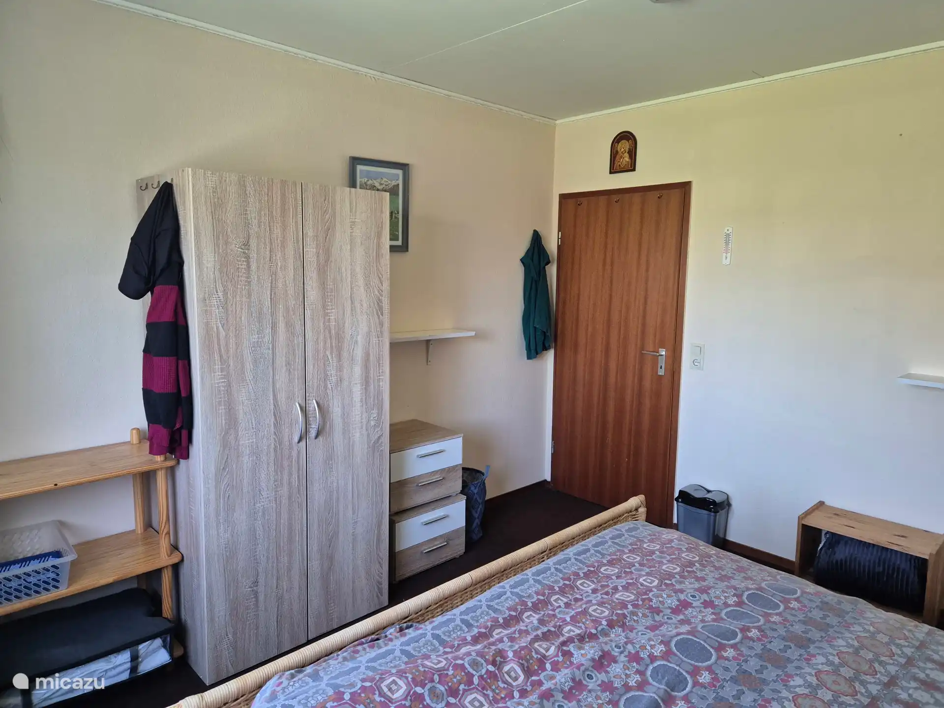 Spacious bedroom with double bed and wardrobe.