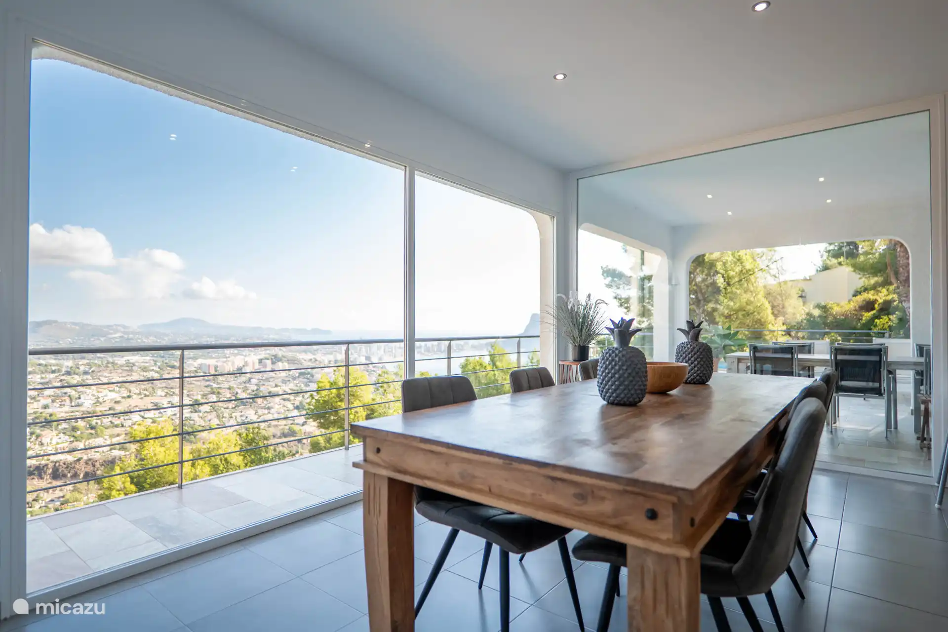 And a beautiful wooden dining area with luxurious armchairs.