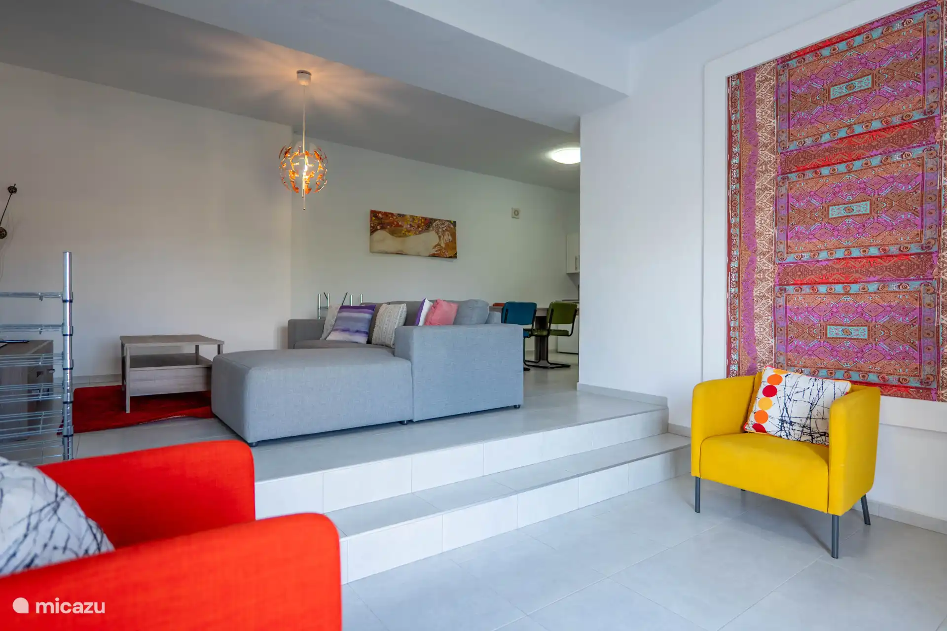 The living room has a corner sofa and dining area with open kitchen.