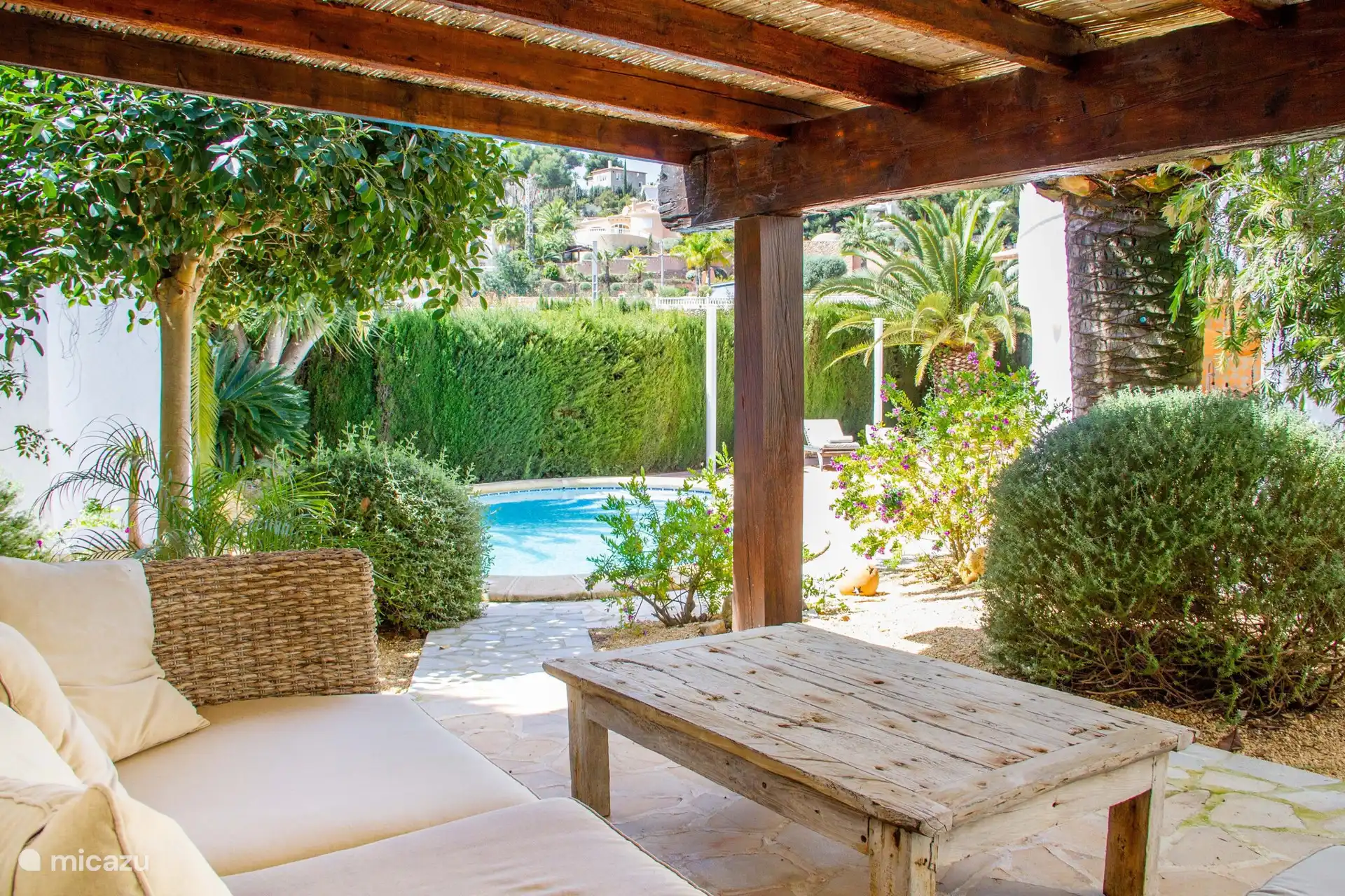 Bajo el toldo hay un cómodo salón, ideal para tomar una copa a la sombra.