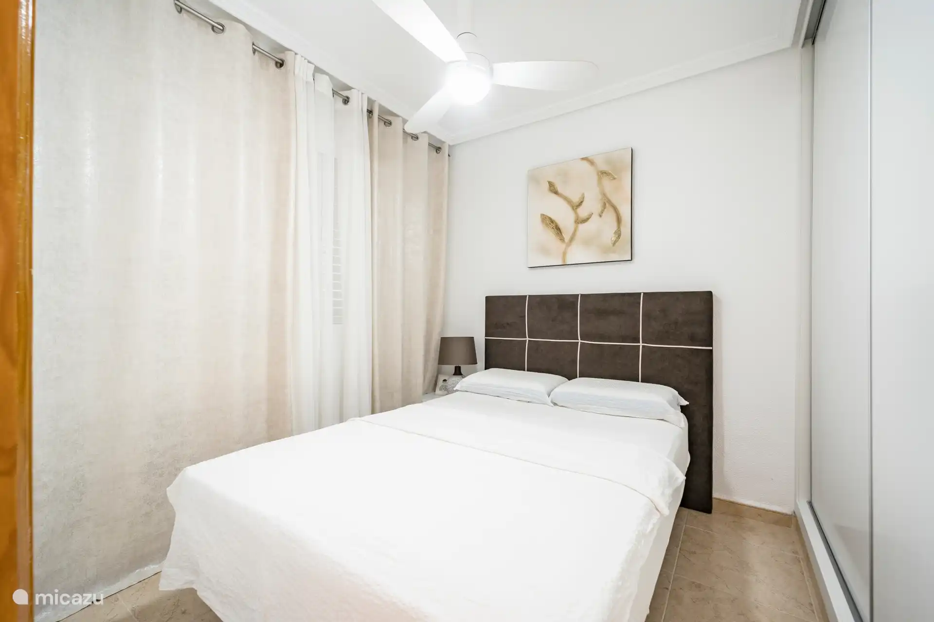 Ground floor bedroom, including fan and built-in wardrobe