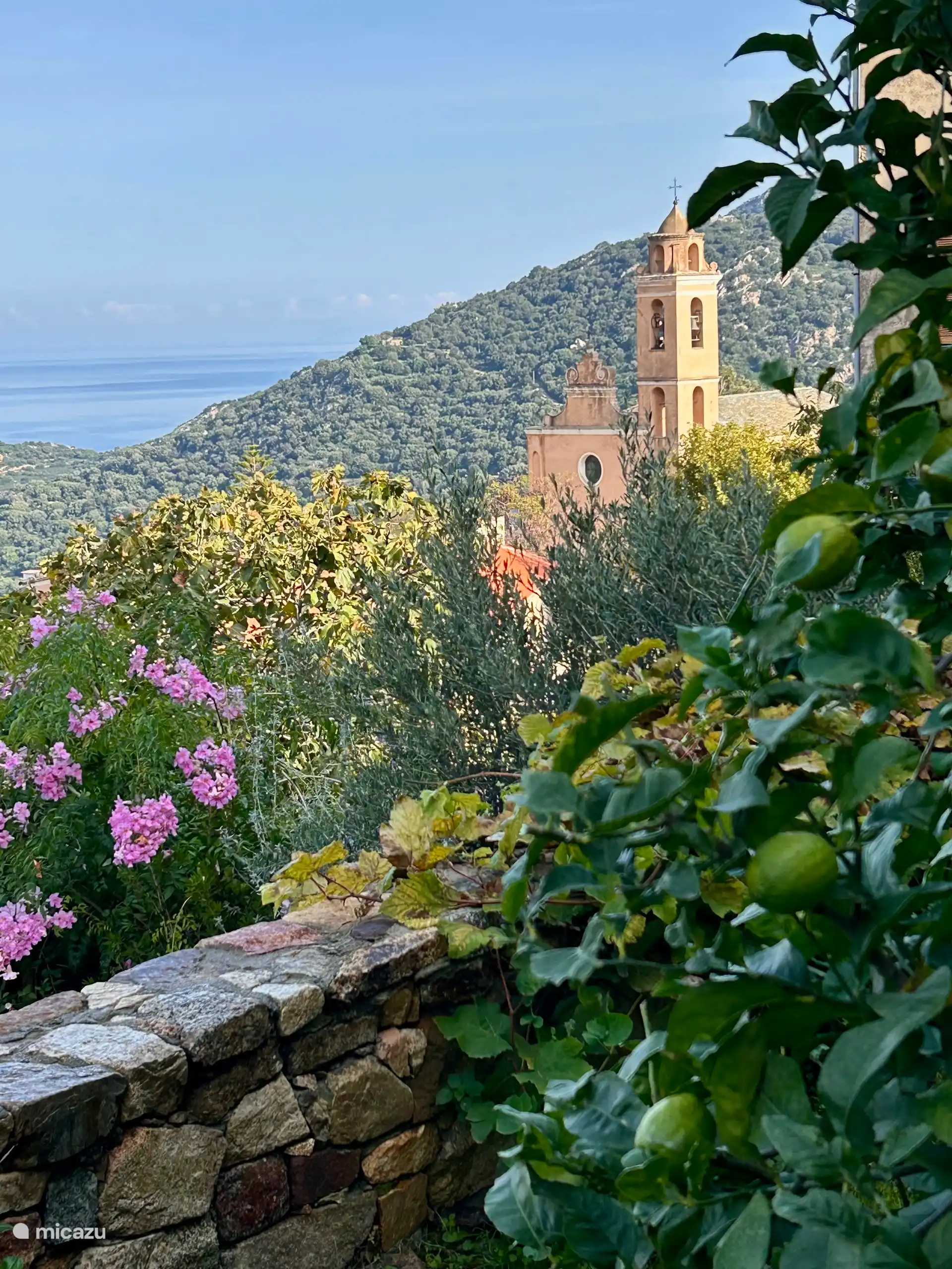 View from the pool of the listed village church, and the sea