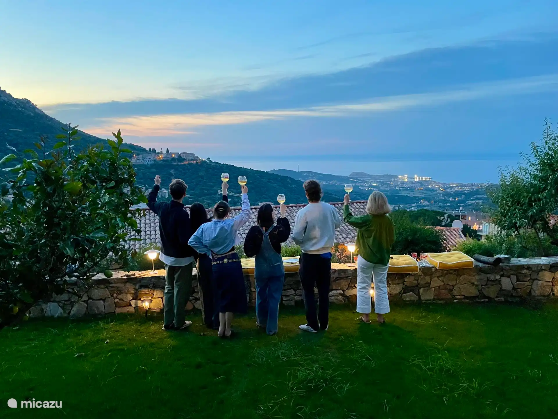 Aperitif in the garden, with a view of the sea and the illuminated village