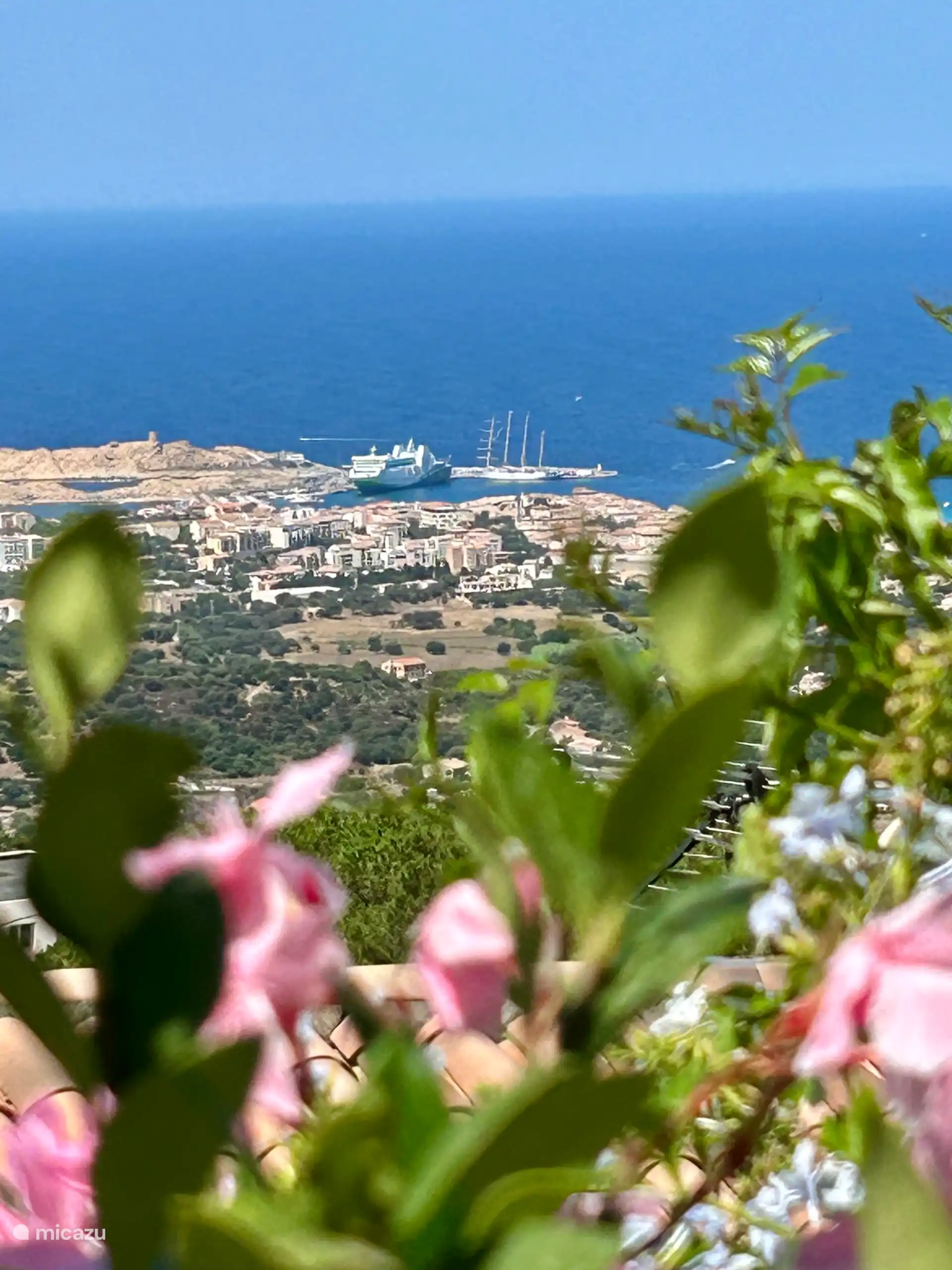 View from the swimming pool, over the port of Ile Rousse, the flat and the lees of the Pietra