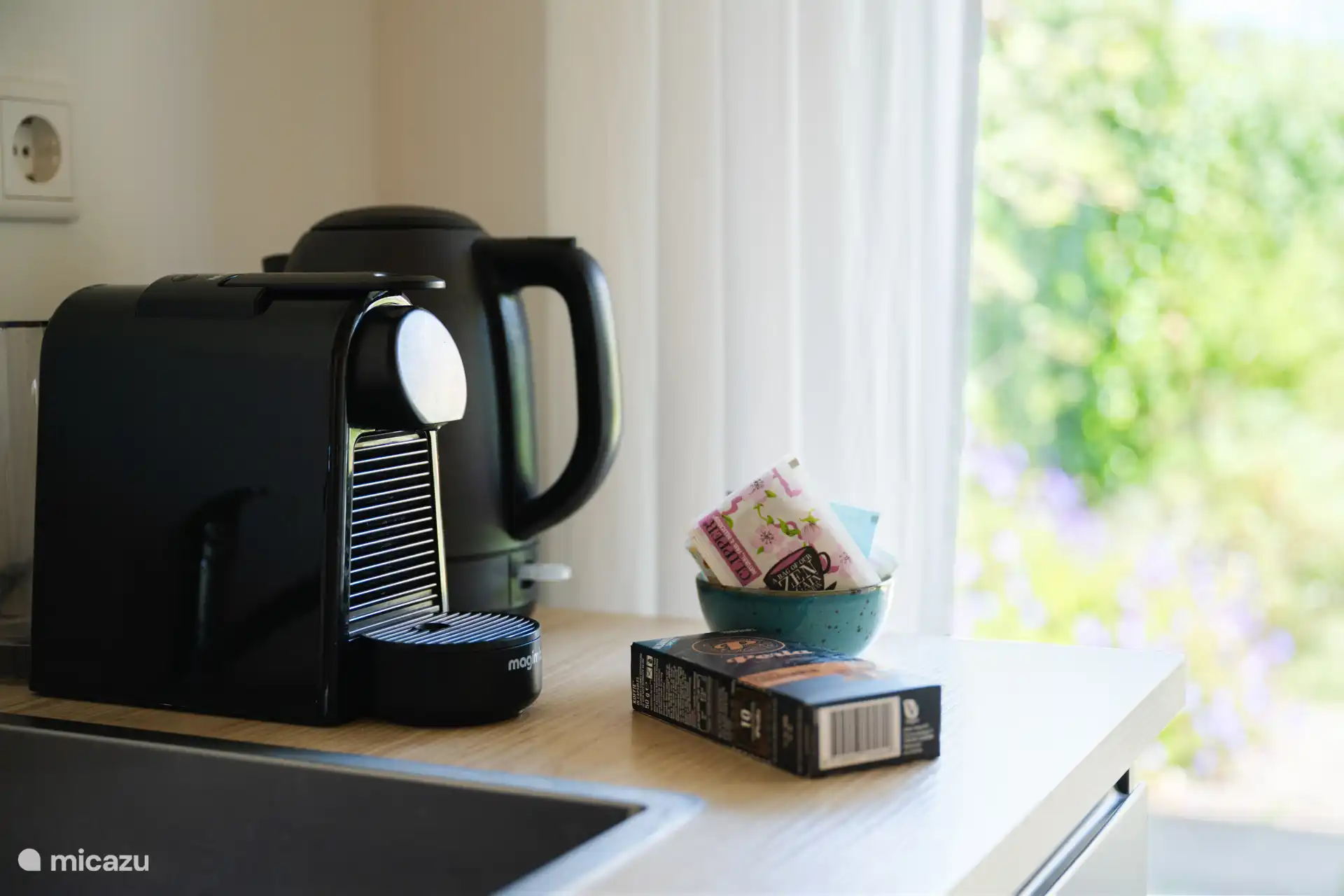 Coffee maker and kettle in the well-equipped kitchen