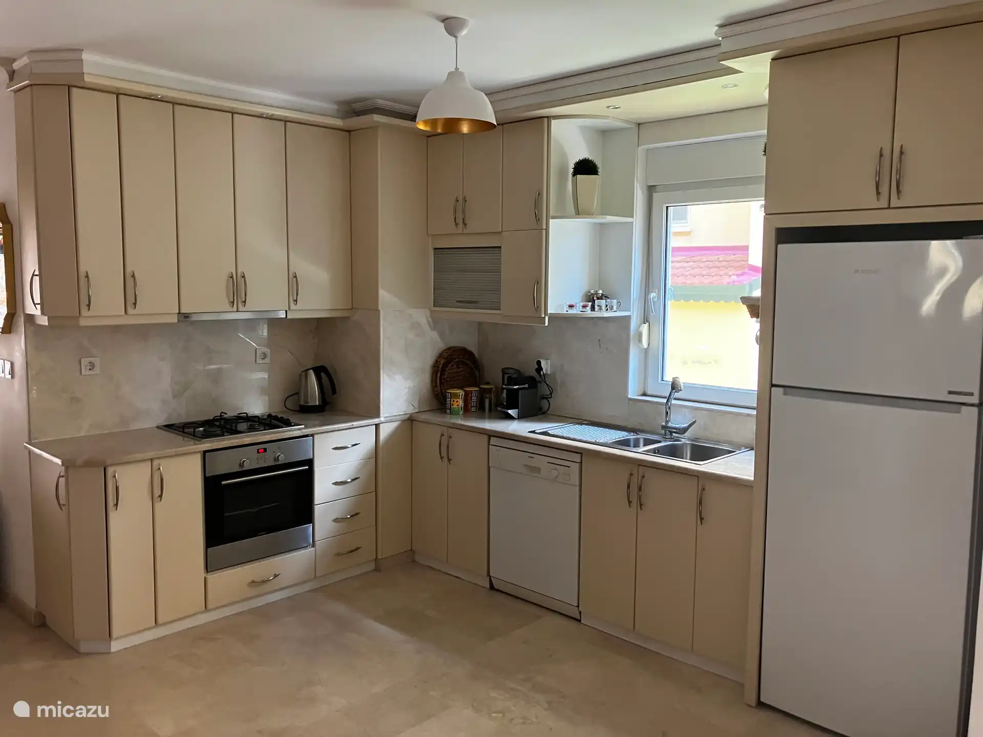 Kitchen complete with oven, microwave, fridge with freezer compartment, dishwasher and Nespresso coffee machine.