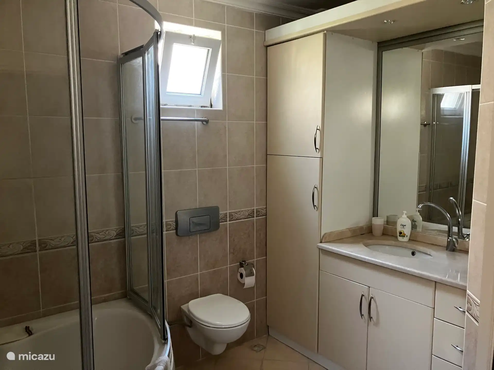 Last door in the hallway gives access to a spacious bathroom with large shower and toilet.