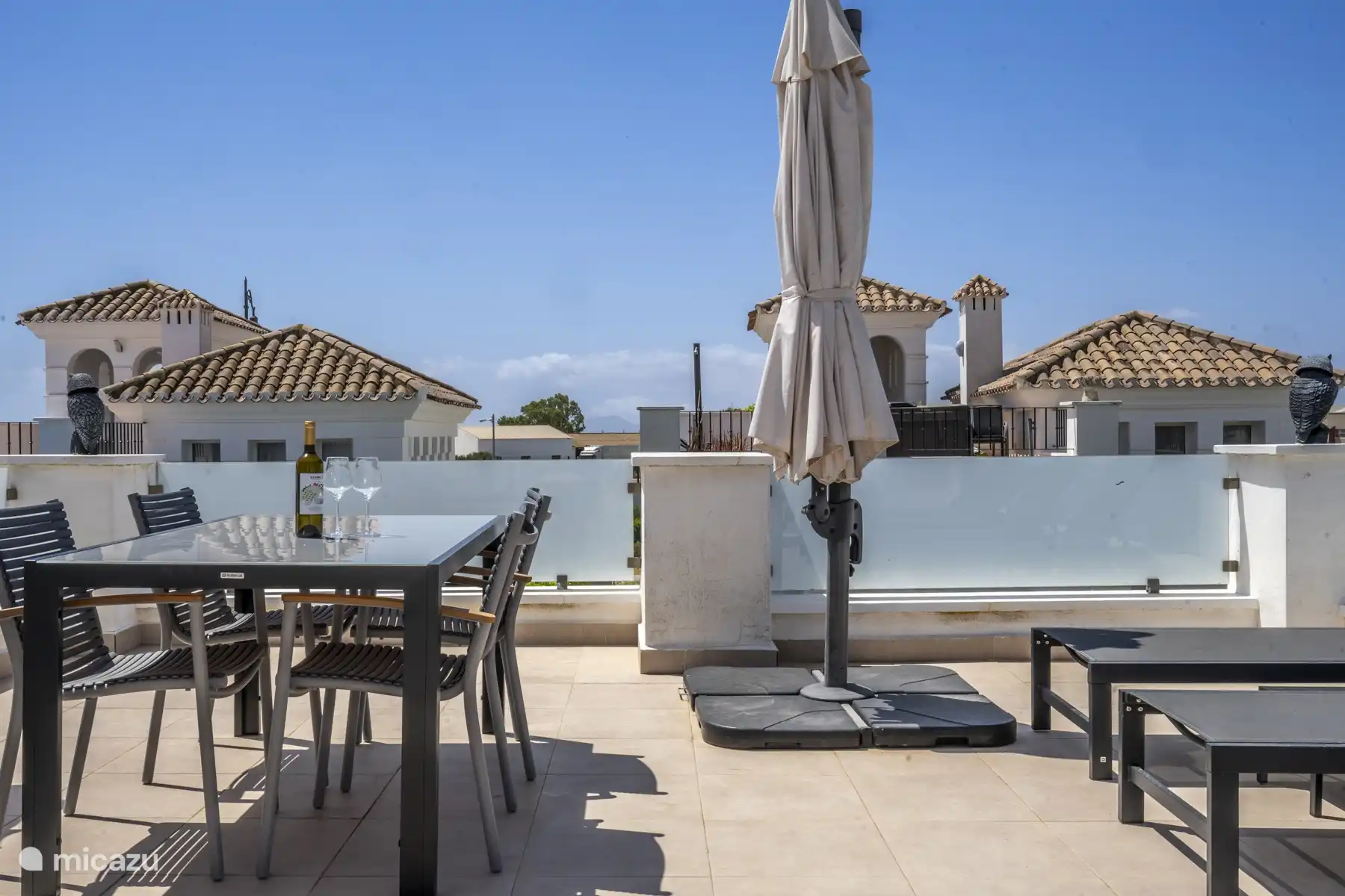 Sun terrace 1st floor, with a bottle of Spanish wine that you will find in the welcome pack.