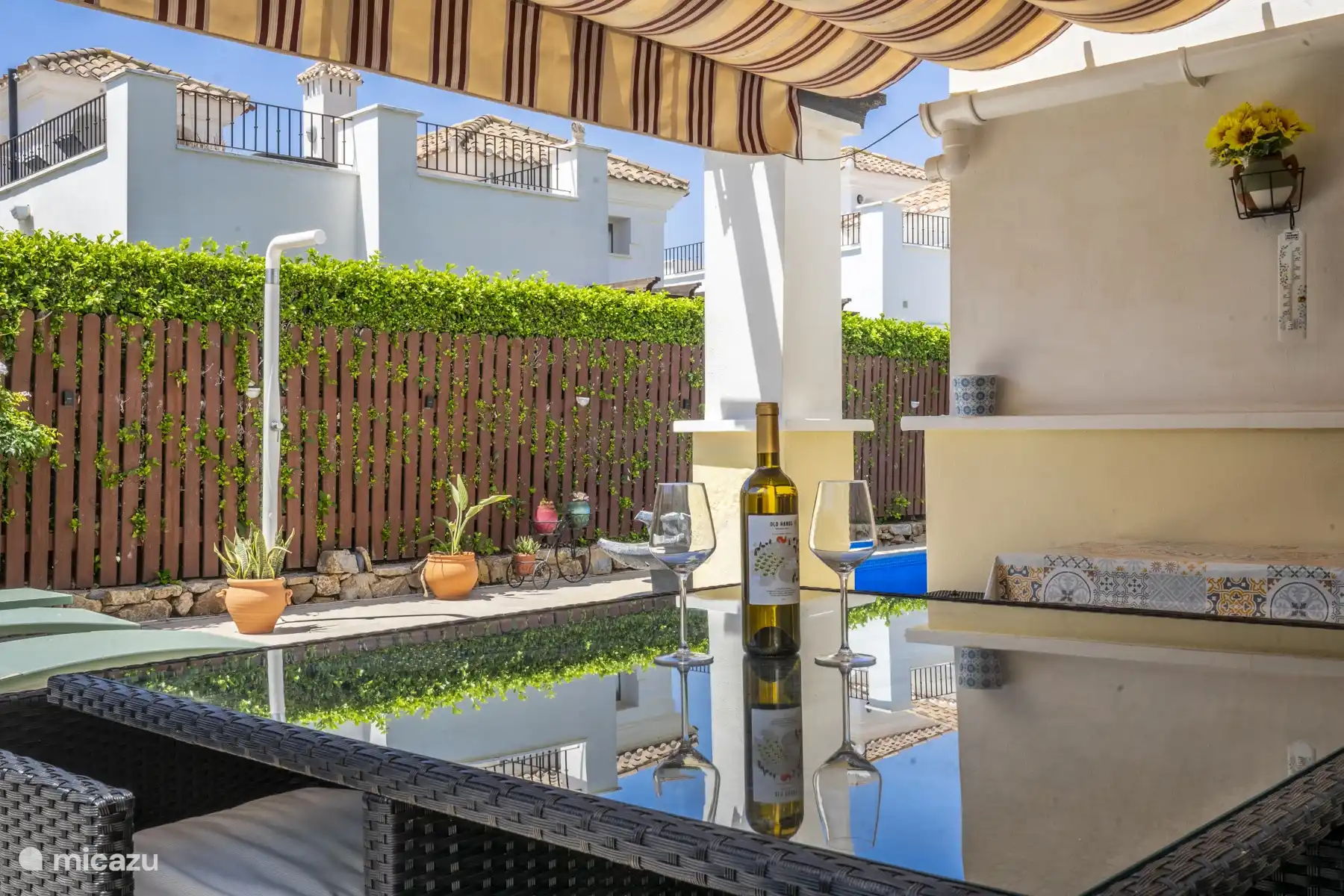 Covered terrace on the ground floor with outdoor shower.
