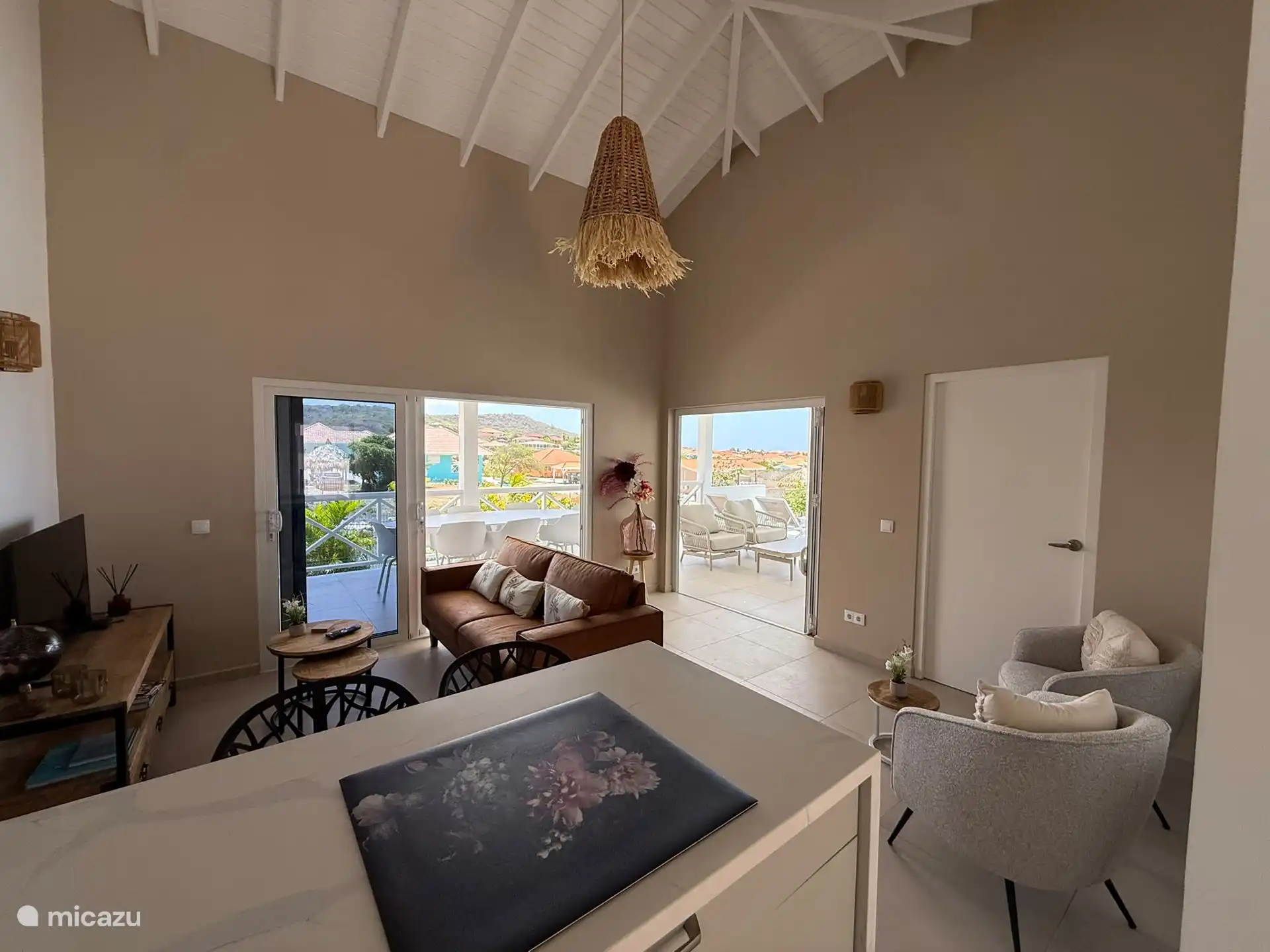 Wohnzimmer ansprechend dekoriert, mit Klapp- und Schiebetüren, die die Veranda und das Pool+Deck durchlaufen