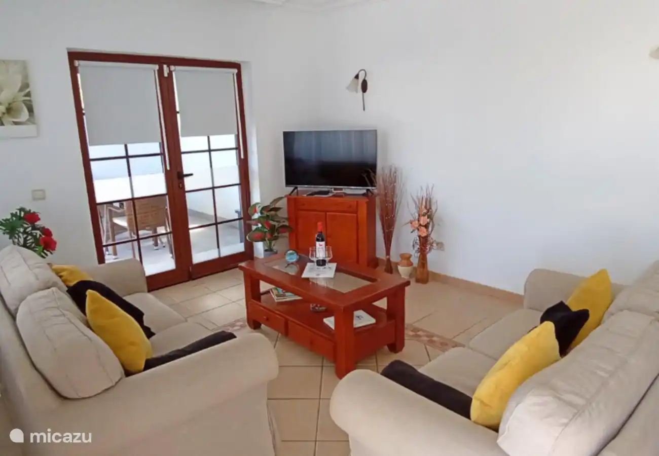 The living room has two comfortable sofas and a 40-inch TV with international channels.