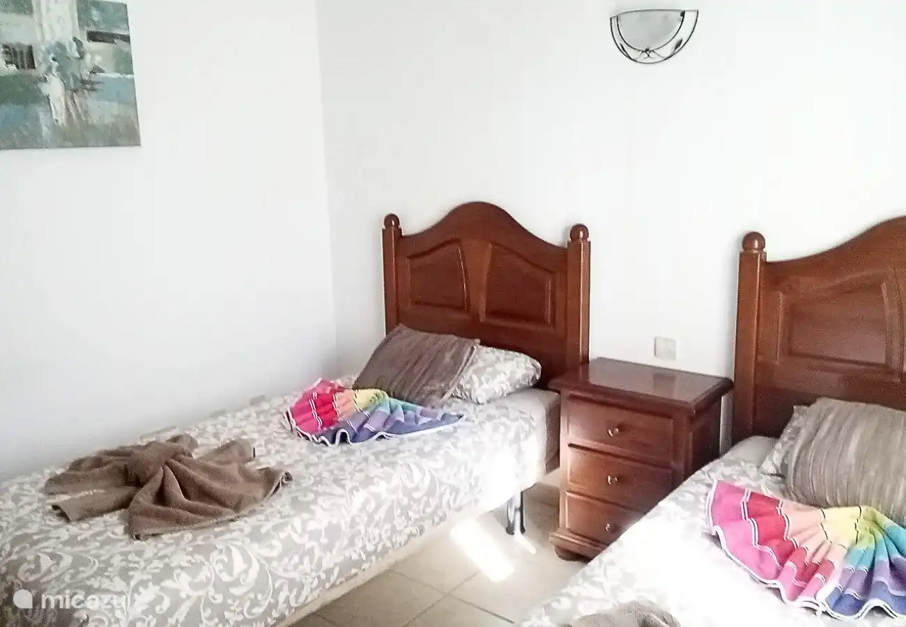 The second bedroom has 2 single beds.