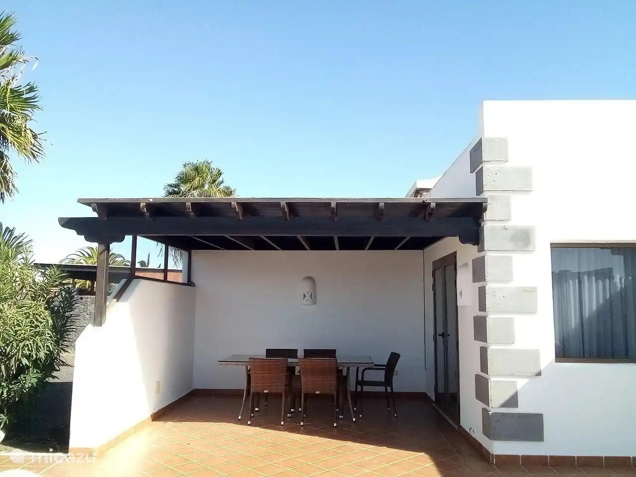 The dining area can be reached through the patio doors from the living room and is covered so you can also sit in the shade. 