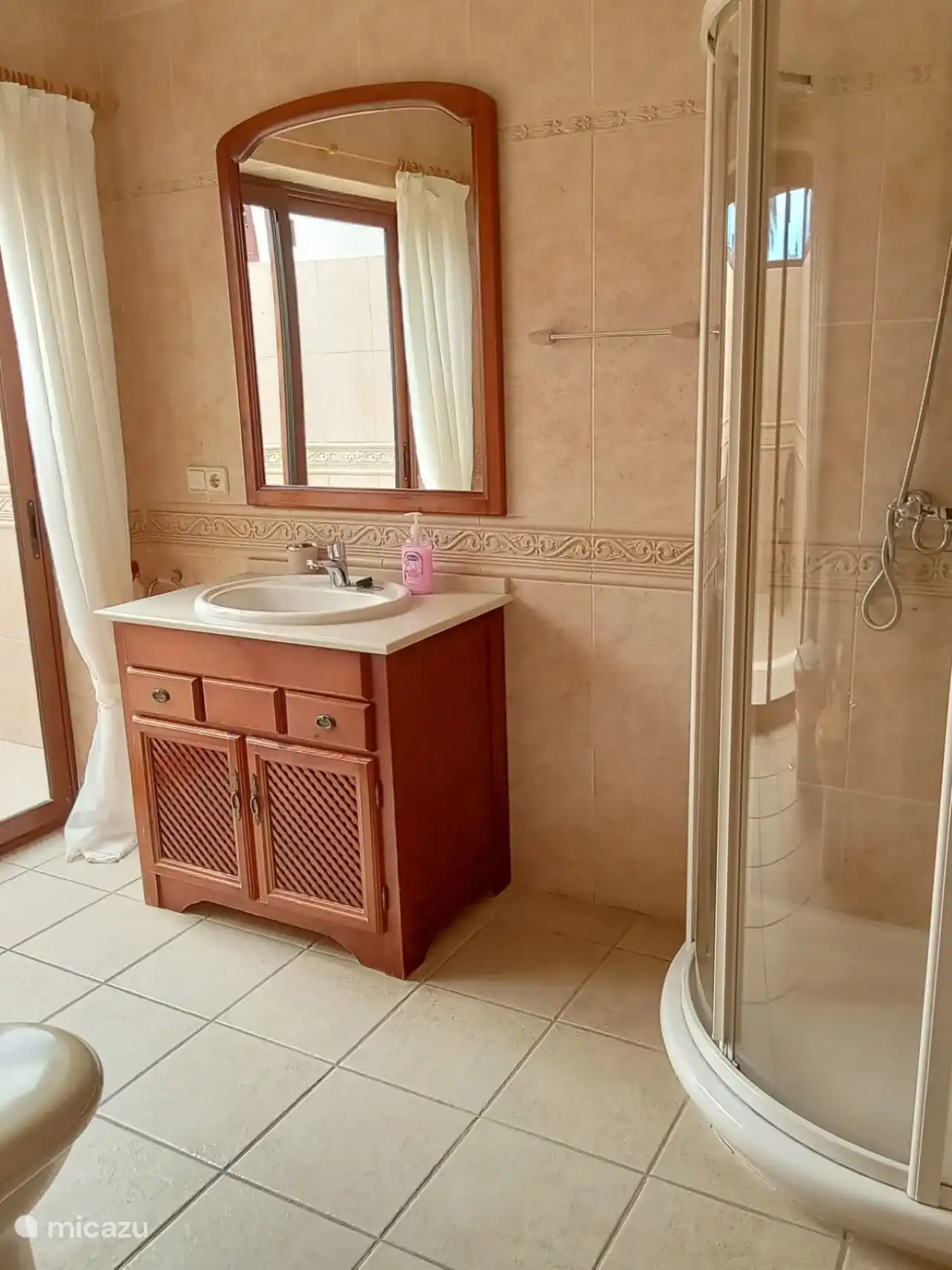 En-suite bathroom with shower, toilet and sink.
