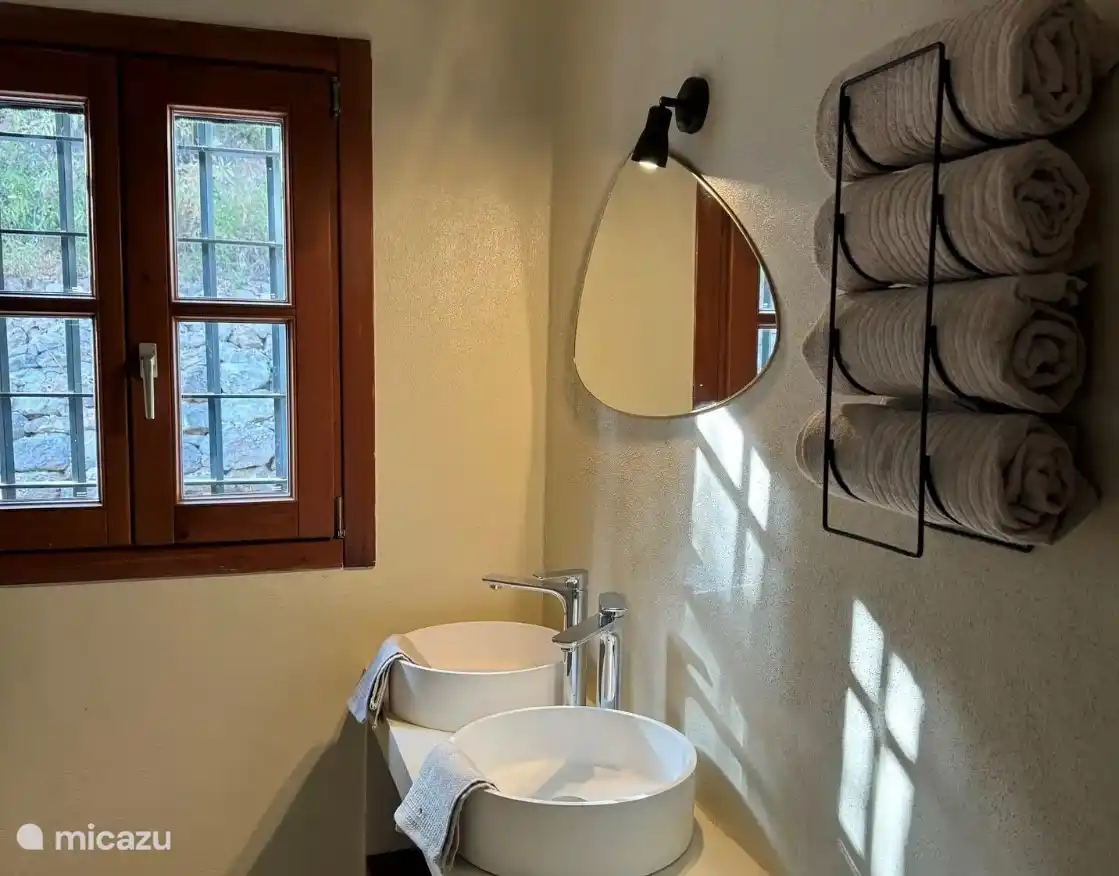 Spacious en-suite bathroom, adjacent to the master bedroom with double sinks and a sleek, modern finish.