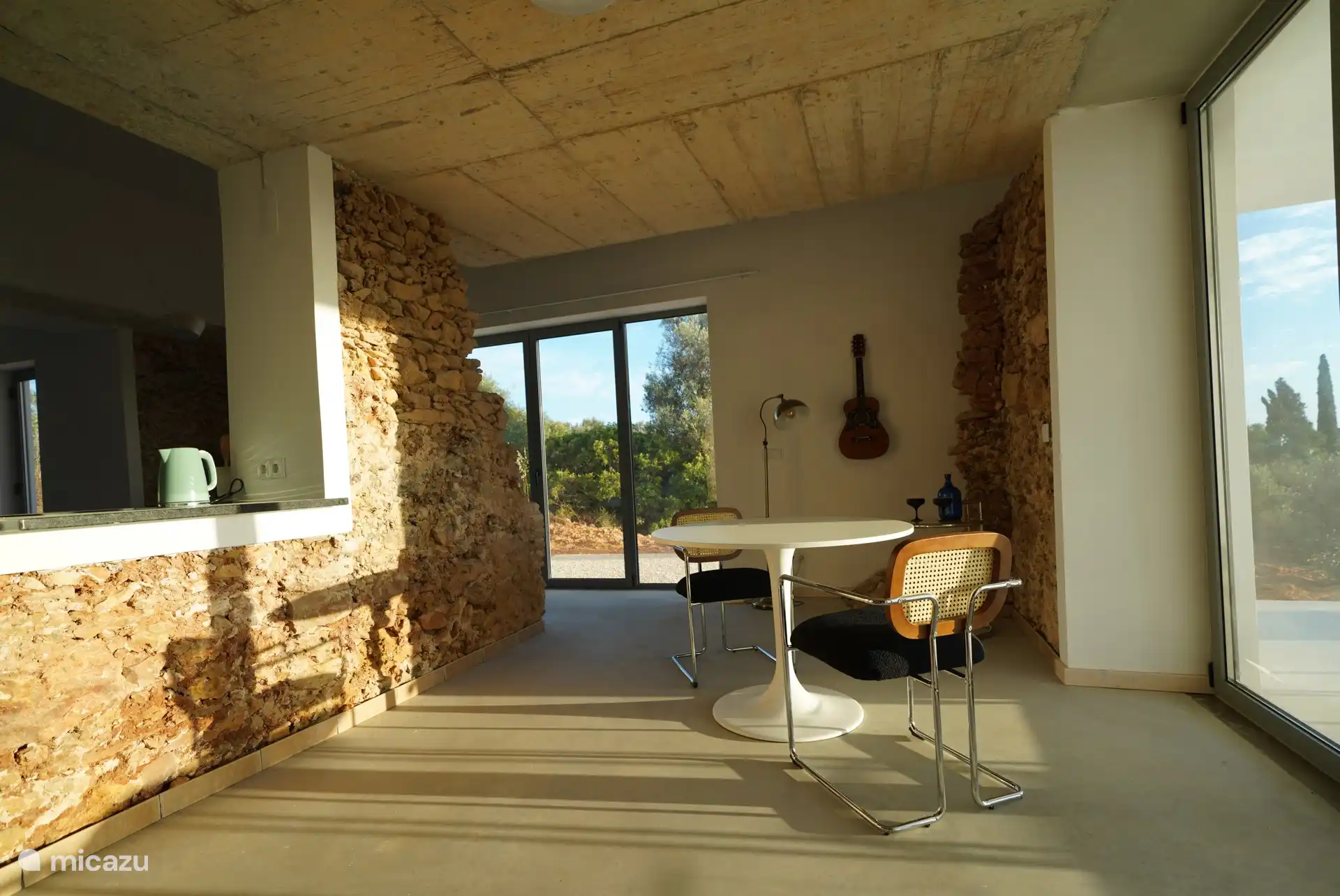 Dining table adjacent to covered west terrace