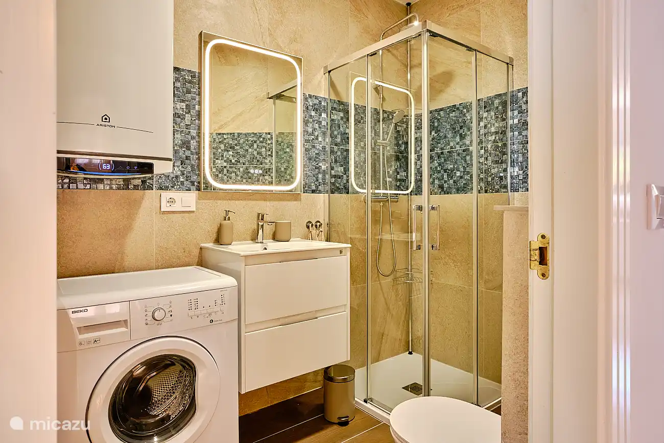 Badezimmer mit Dusche, Wasserkocher und Waschmaschine