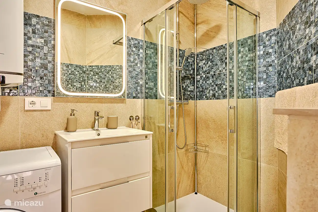 Badezimmer mit Dusche, Wasserkocher und Waschmaschine