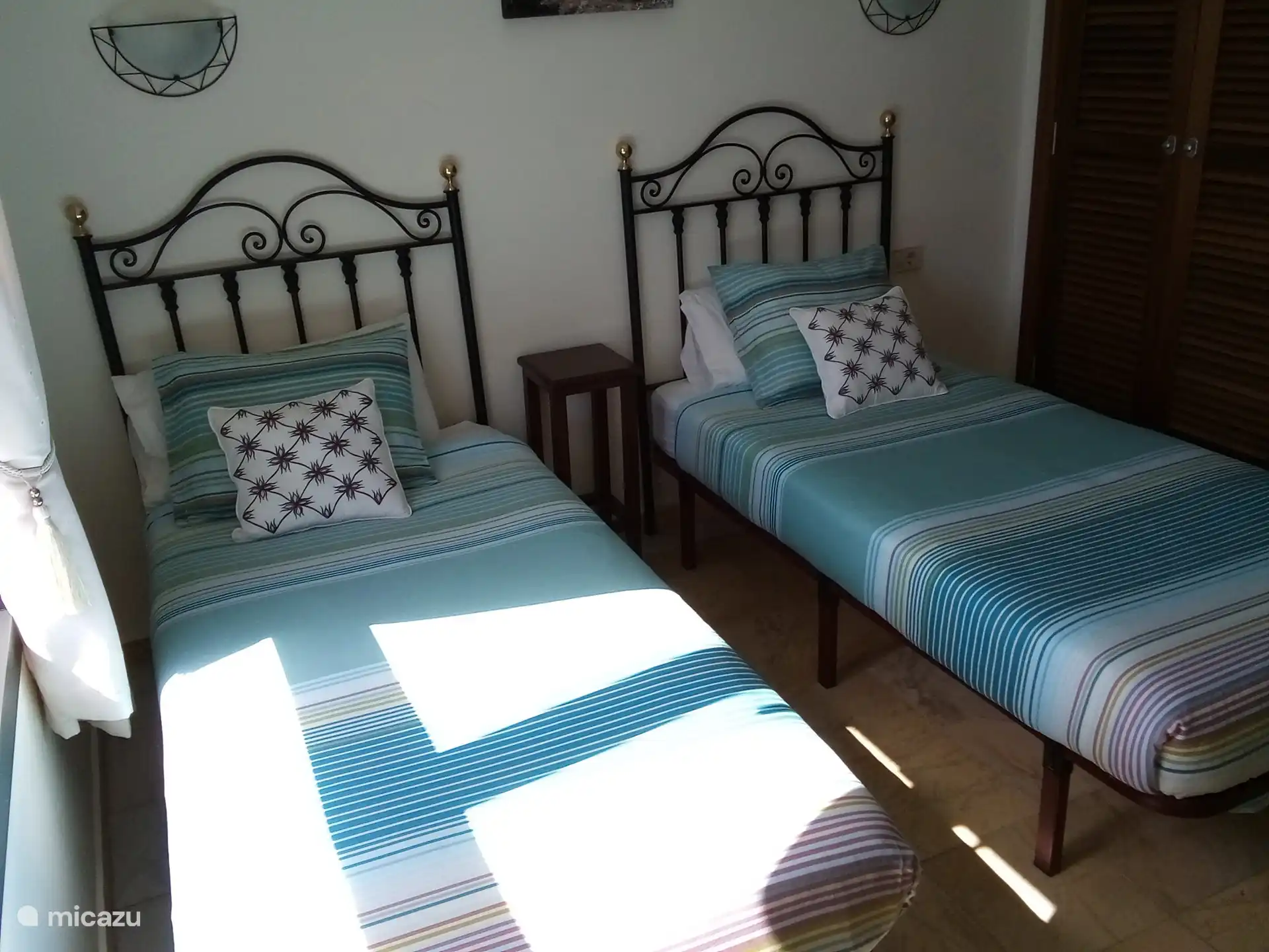 The second bedroom has two single beds, air conditioning and a bathroom with walk-in shower.