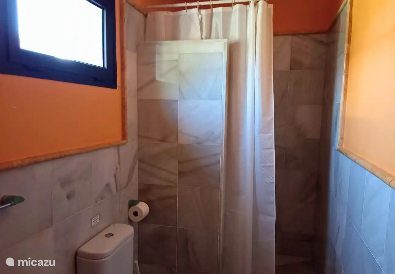 a bathroom with walk-in shower, toilet and sinka bathroom with walk-in shower, toilet and sink