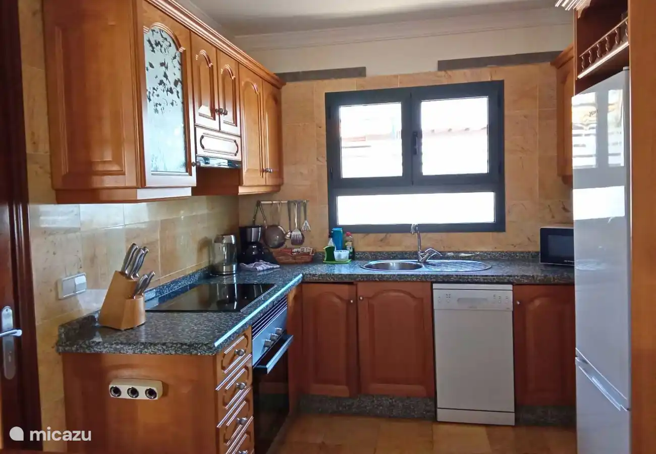 The fully equipped kitchen has a microwave, dishwasher, oven, coffee maker, toaster and fridge freezer. 