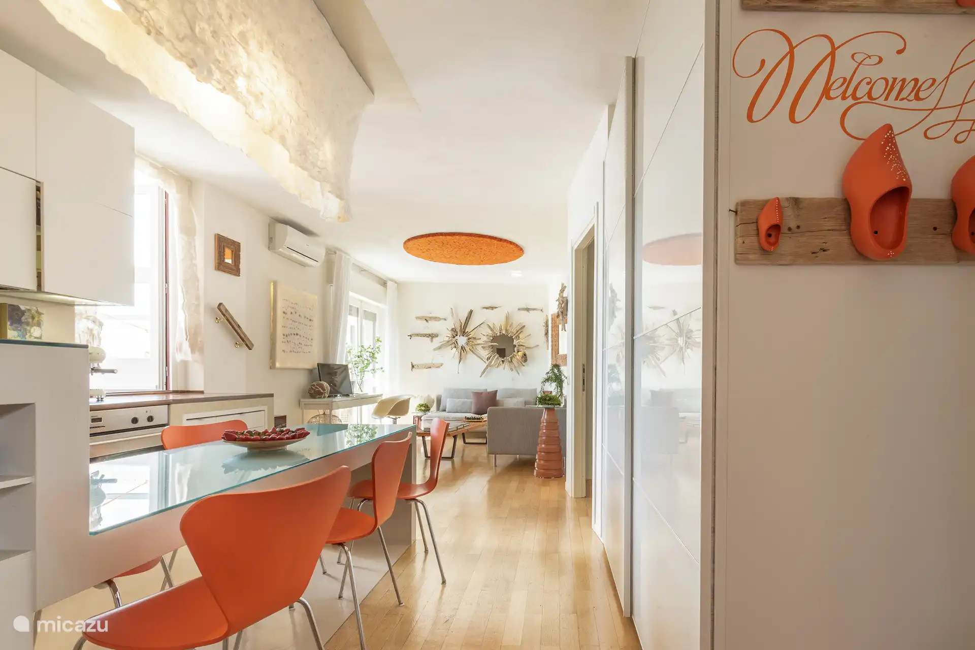 Cocina luminosa y bien equipada con cafetera espresso Smeg, aire acondicionado y acceso a la terraza a través de cuatro escalones.