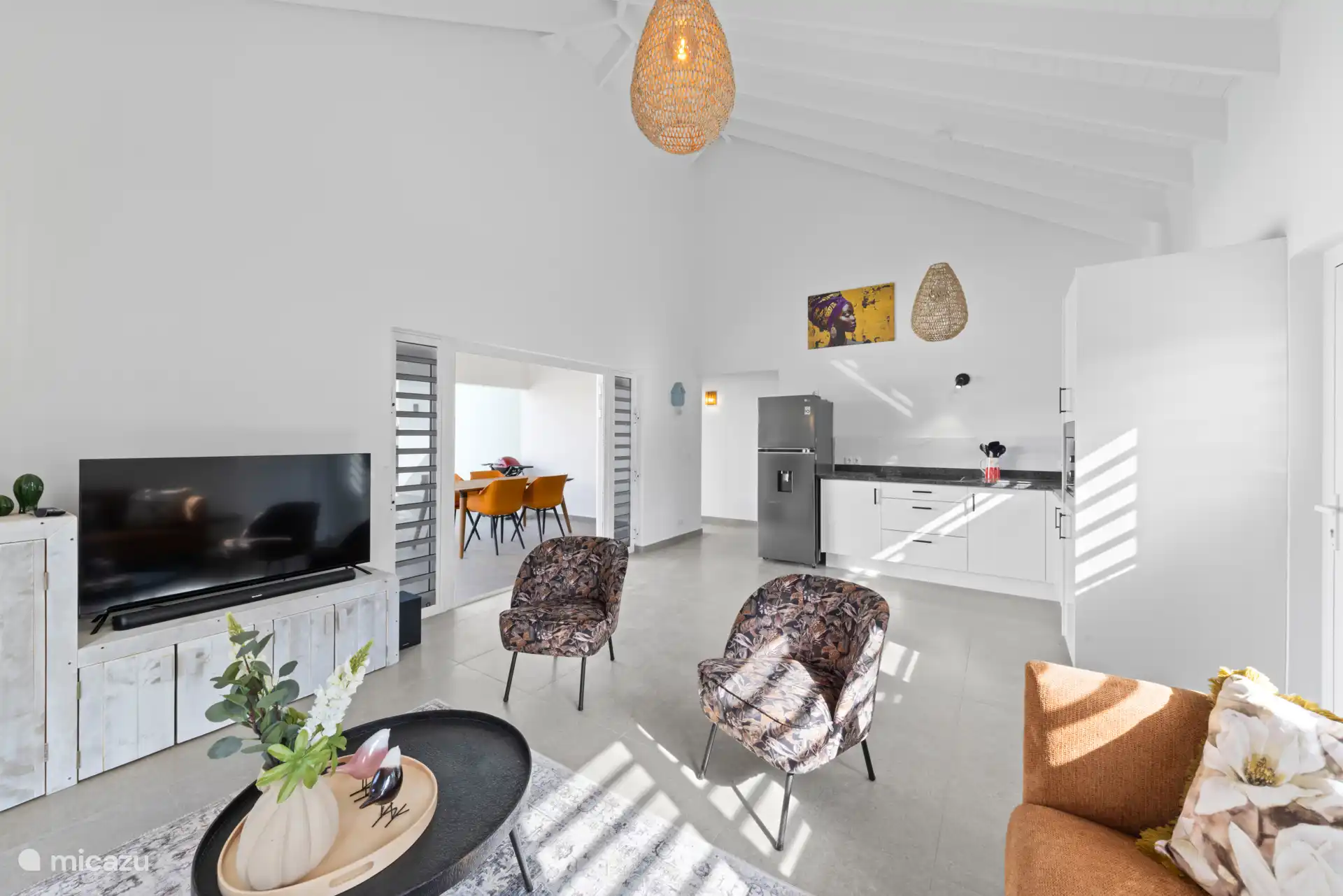 The TV cabinet with the smart TV, soundbar and radio. The house is also beautifully decorated with various elements