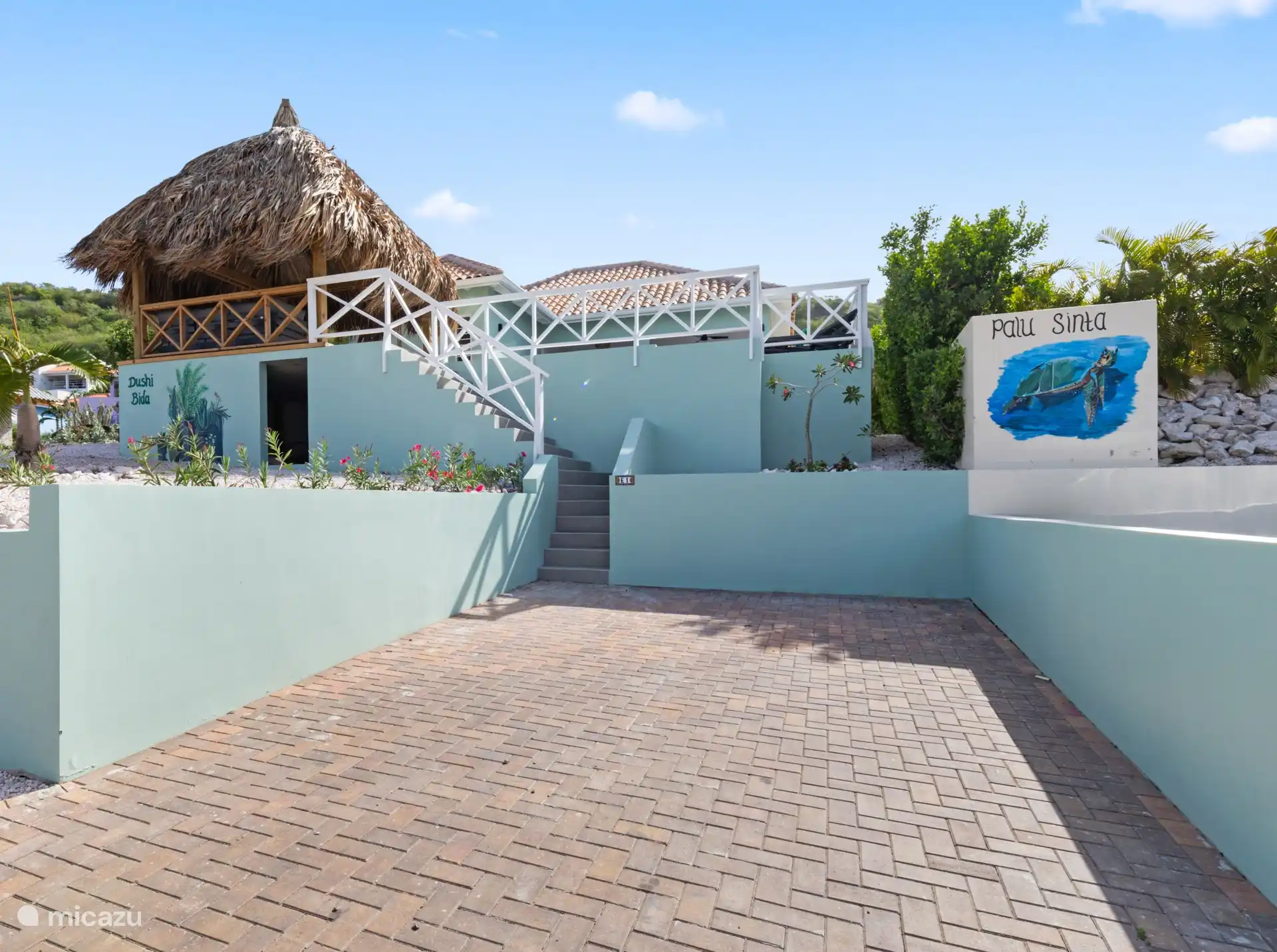 A view of the house at the entrance. The property has a private driveway for parking the car