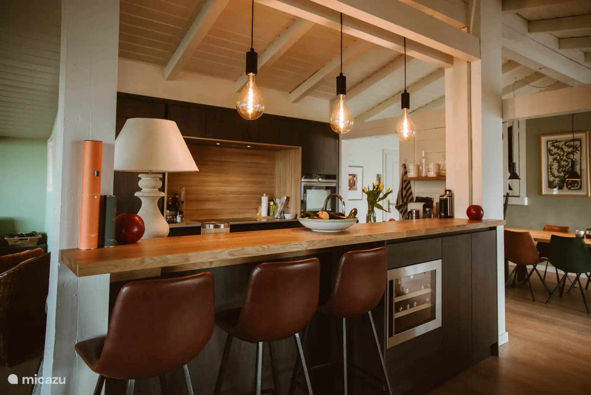 Open kitchen with bar chairs and wine fridge