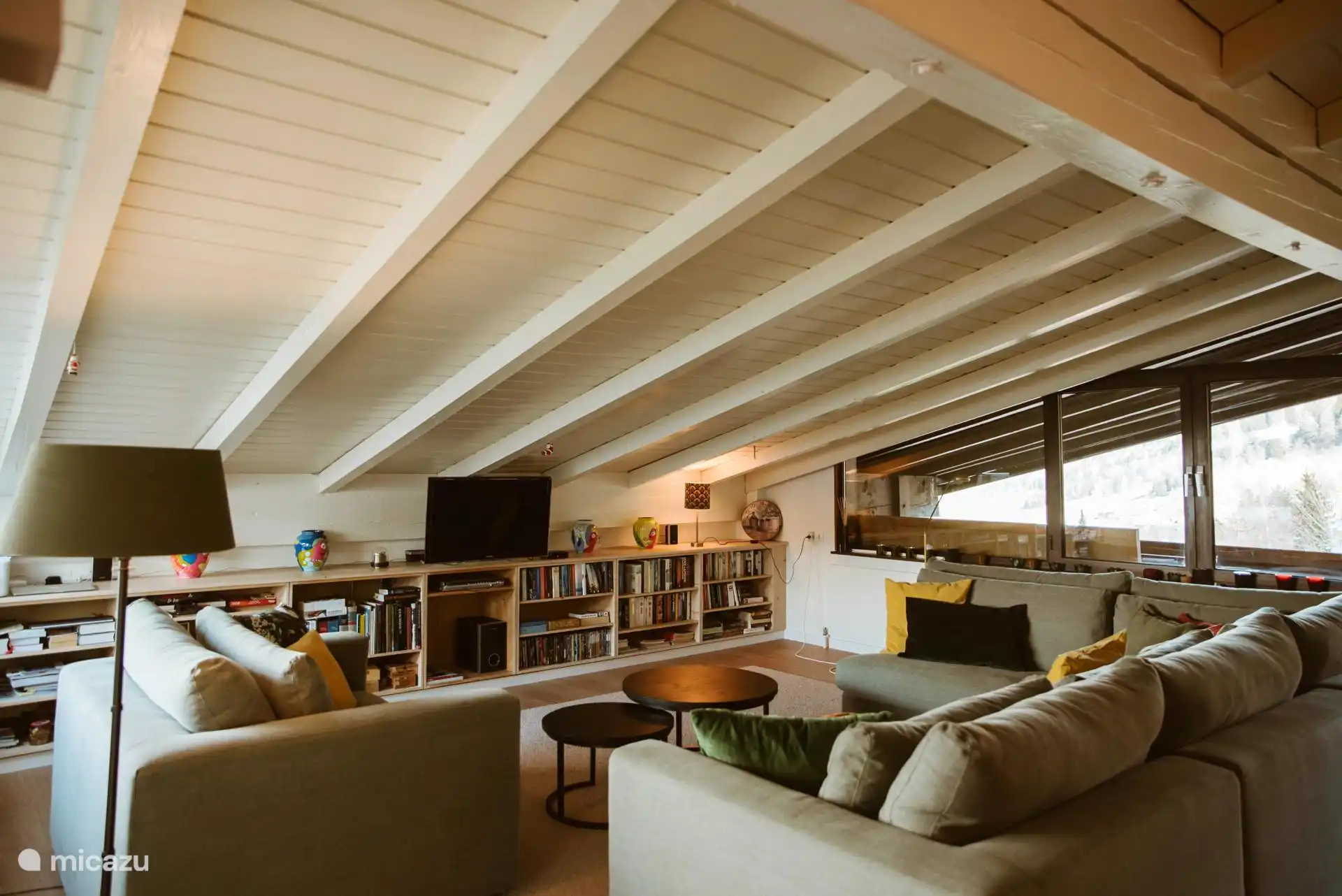 Large sitting area with lounge sofas and smart TV