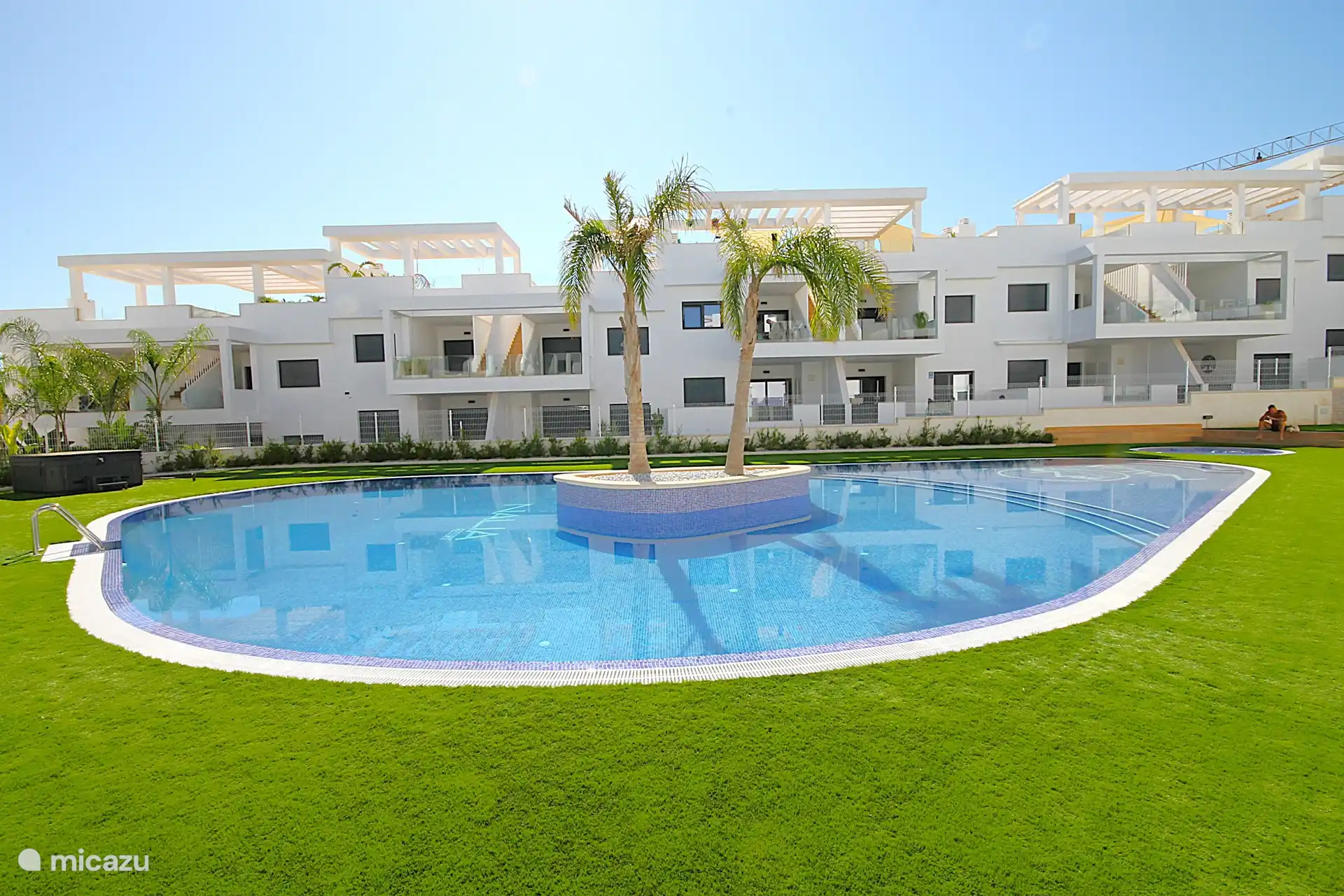 Tropischer Garten mit Swimmingpool, beheiztem Whirlpool und Kinderbecken.