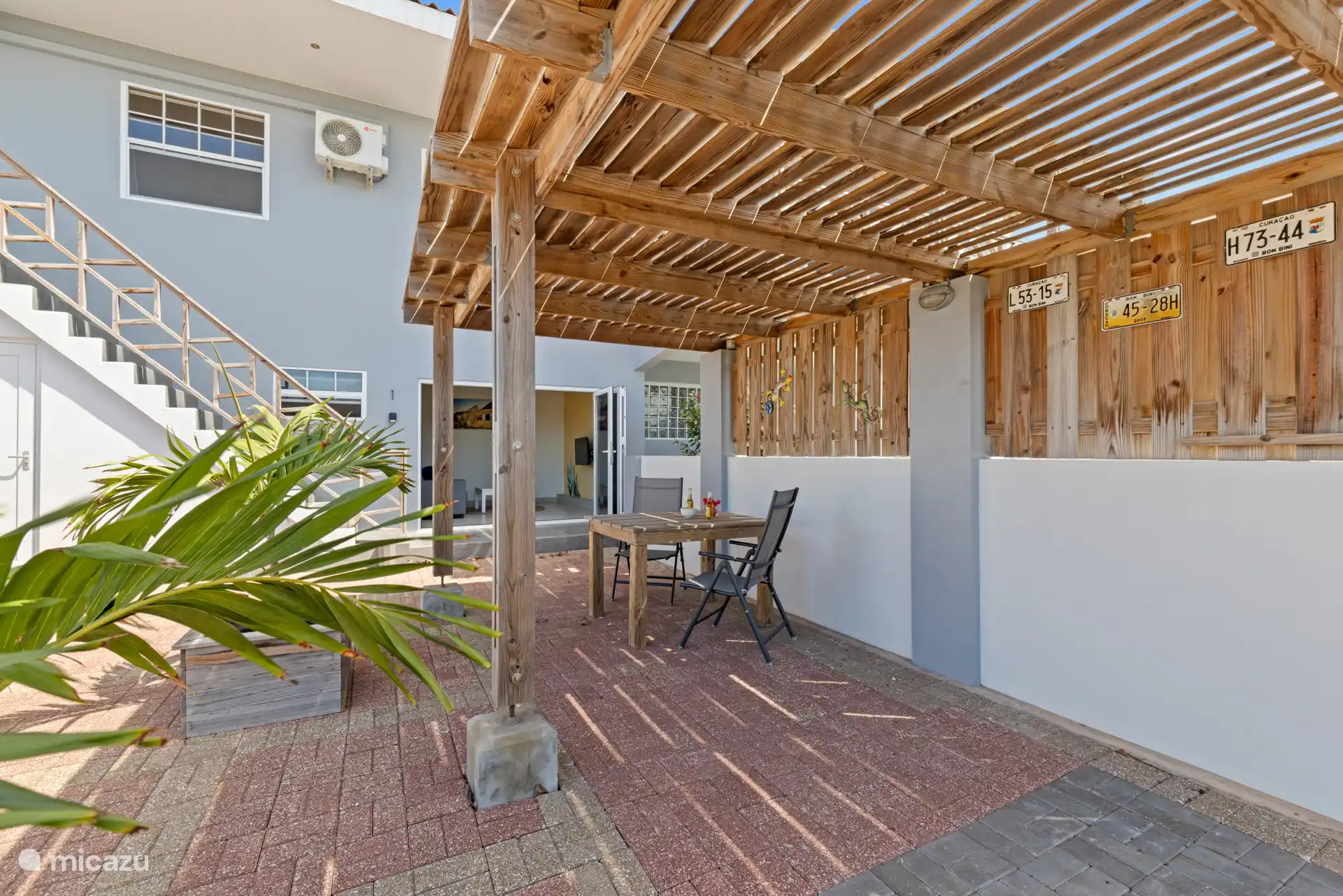 Outdoor seating area in front of the apartment with shade