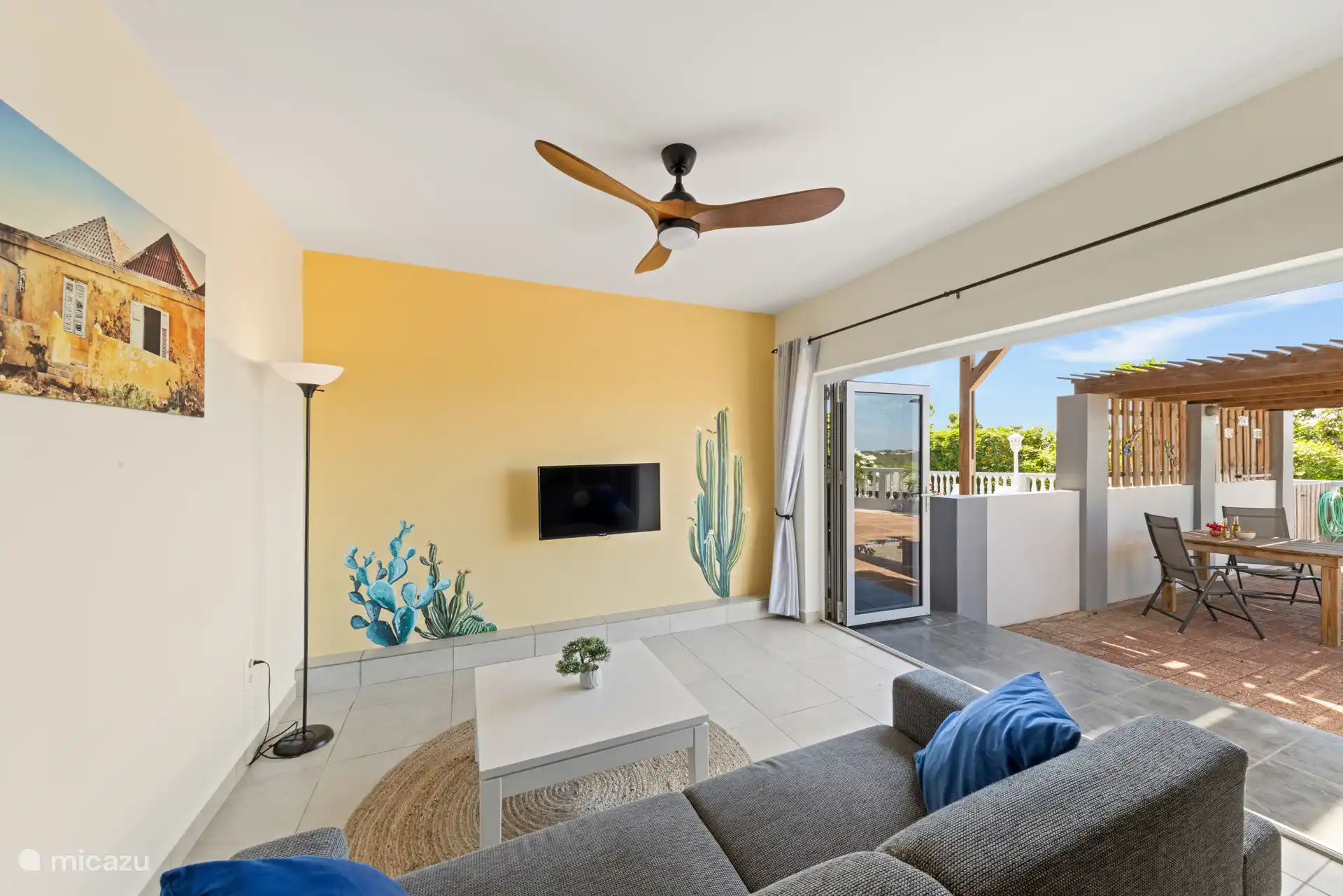 Cozy living room with smart TV and a ceiling fan for some cooling