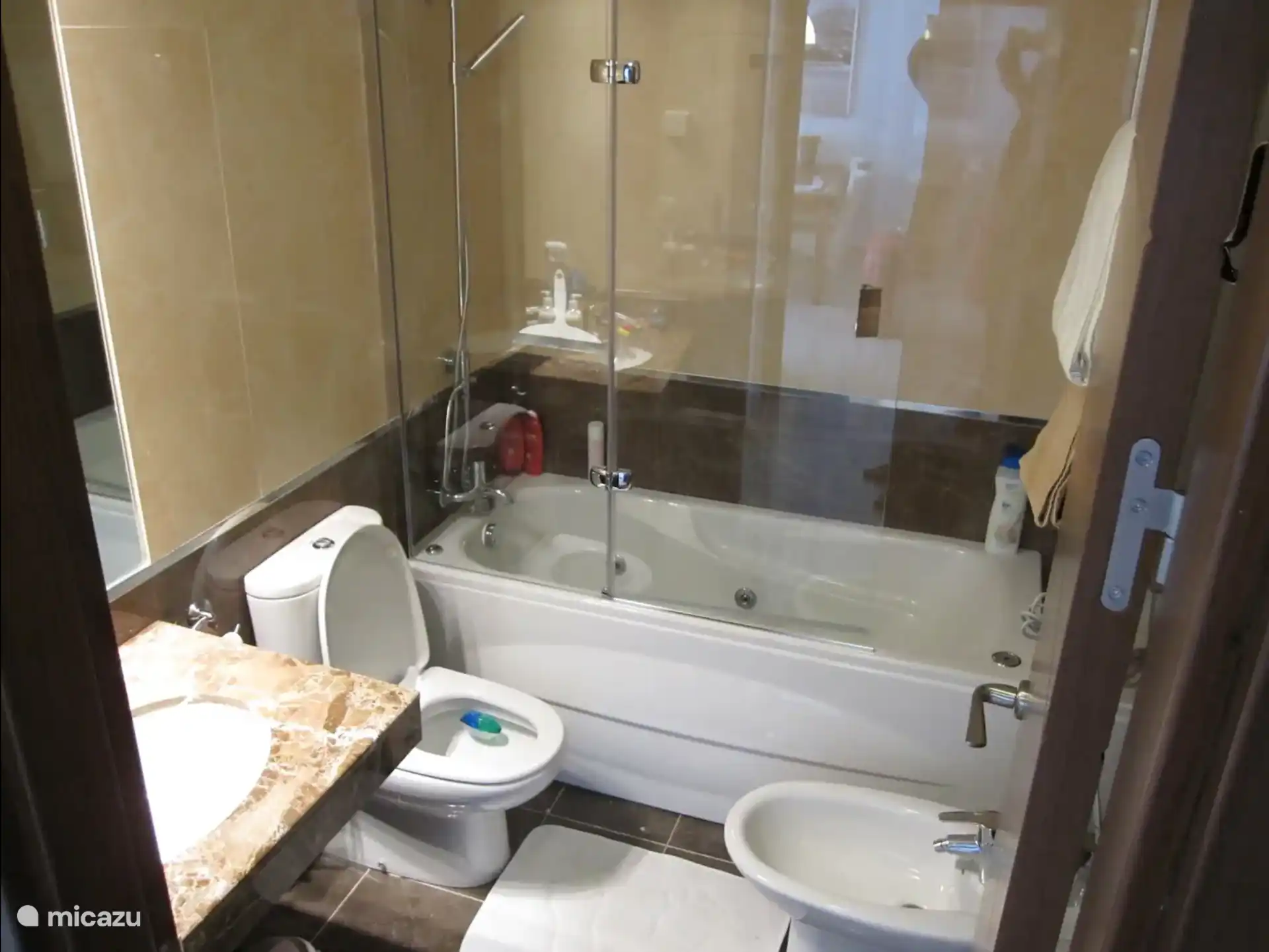 Salle de bain principale attenante
Salle de bain luxueuse avec lavabo, grand miroir, bidet, toilettes et baignoire/douche à remous. Chauffage au sol, porte-serviettes et poignée. 