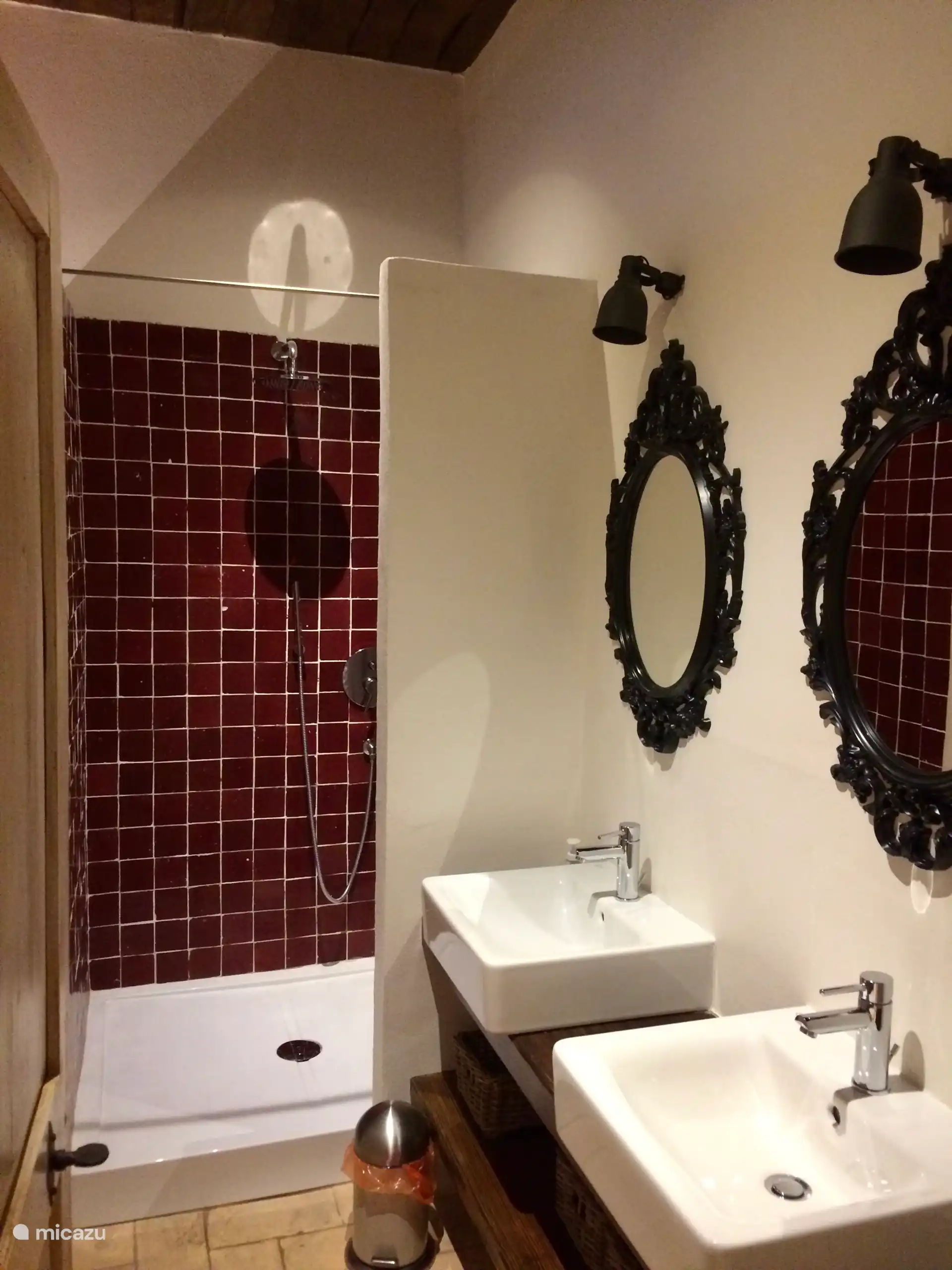Bathroom with double sink belonging to the underground room.