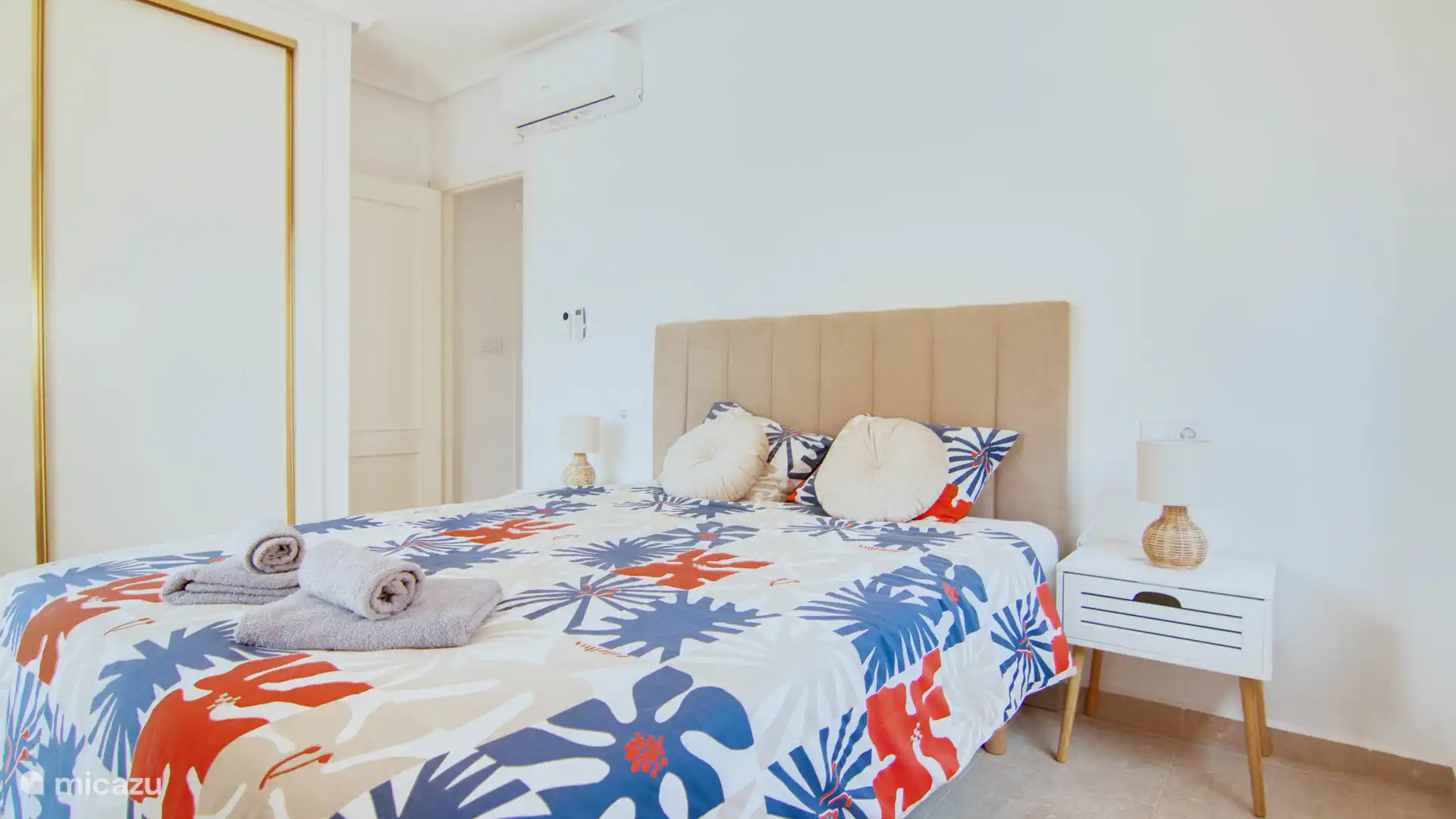 Spacious double bedroom with direct access to a balcony with sea views