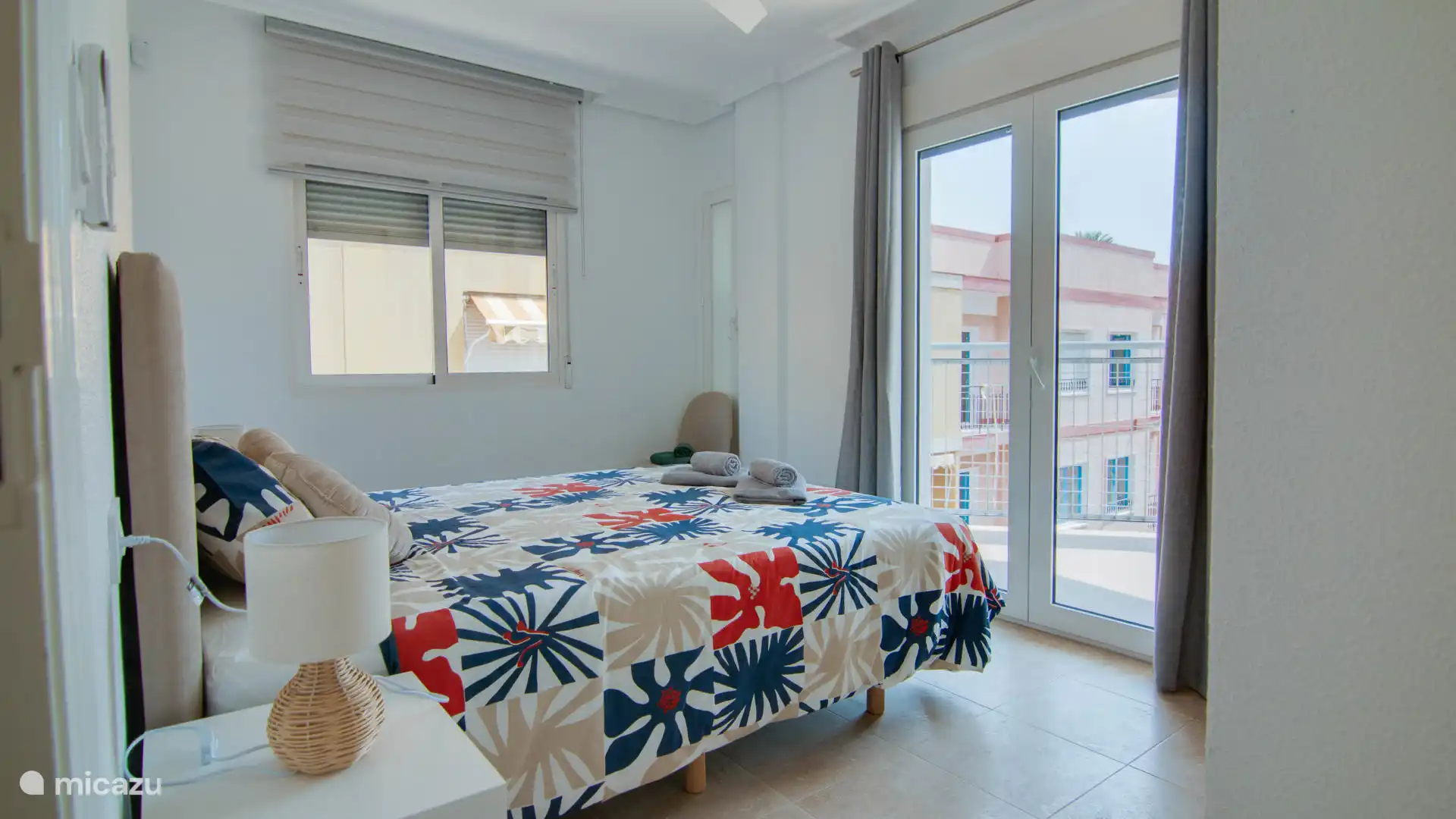 Spacious double bedroom with direct access to a balcony with sea views