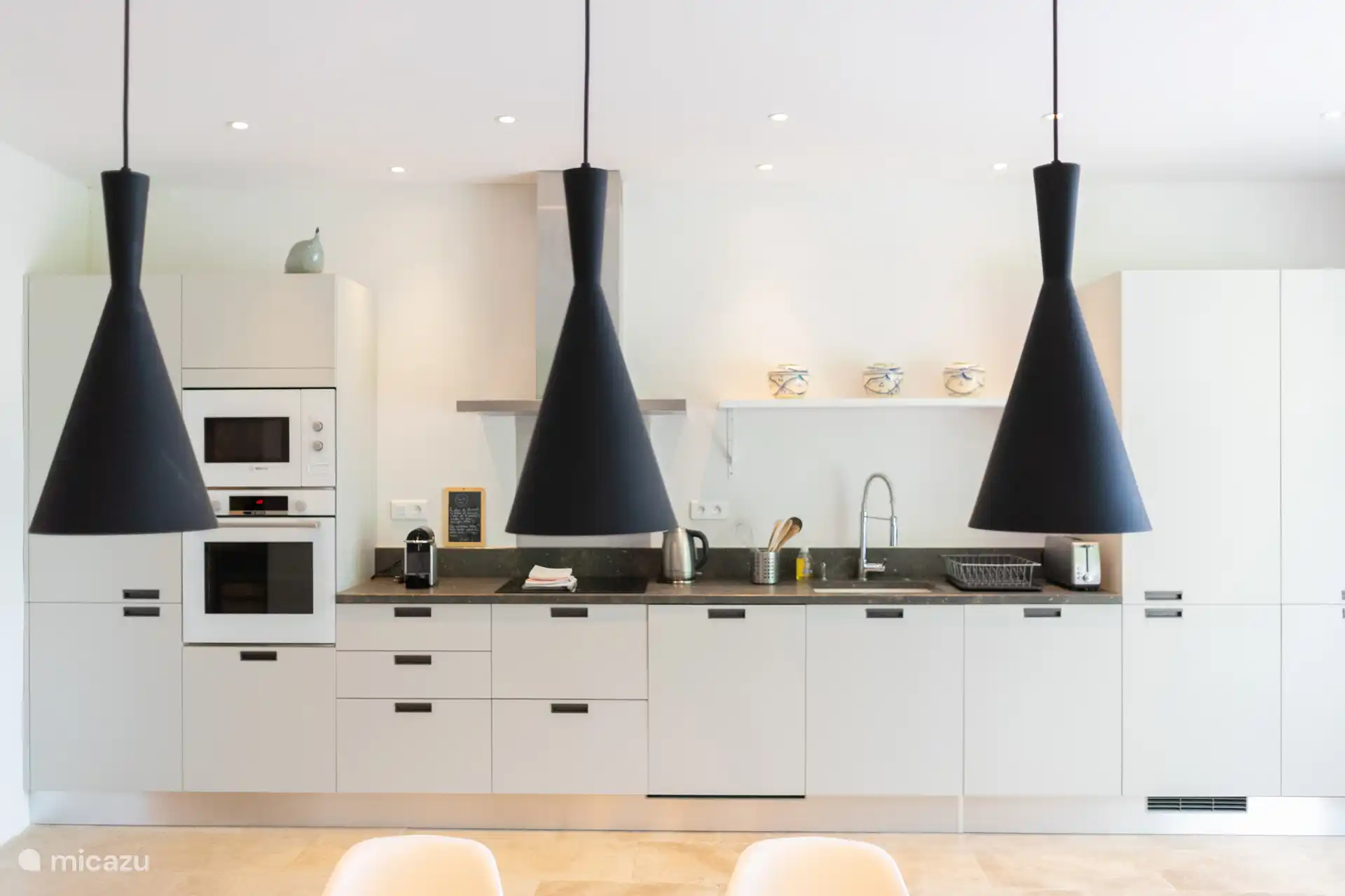 volledig uitgeruste keuken, inductiekookplaat, oven, magnetron, vaatwasser, koelkast/vriezer en wasmachine