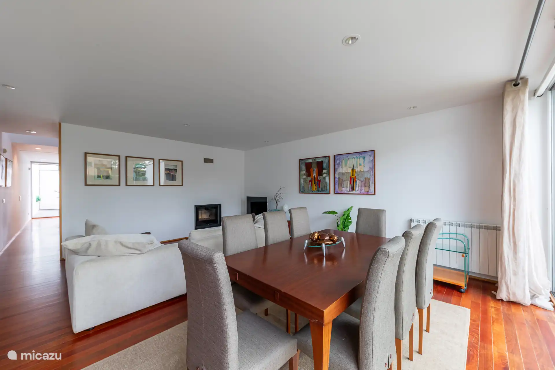 Geräumiges Interieur im Wohnzimmer mit einem Esstisch, einem gemütlichen Sofa und einem TV mit einer großen Auswahl an Kabelkanälen.