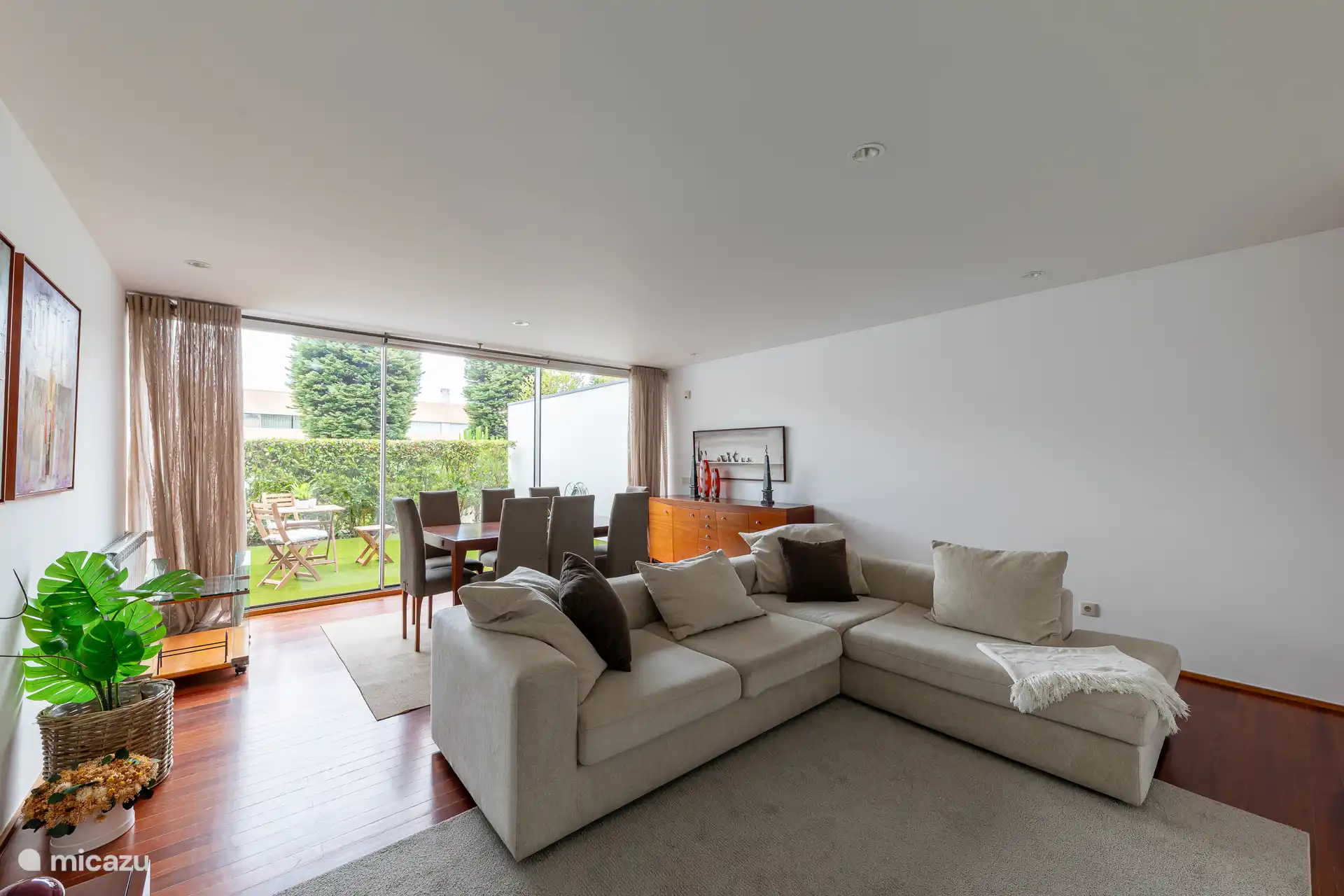 Geräumiges Interieur im Wohnzimmer mit einem Esstisch, einem gemütlichen Sofa und einem TV mit einer großen Auswahl an Kabelkanälen.